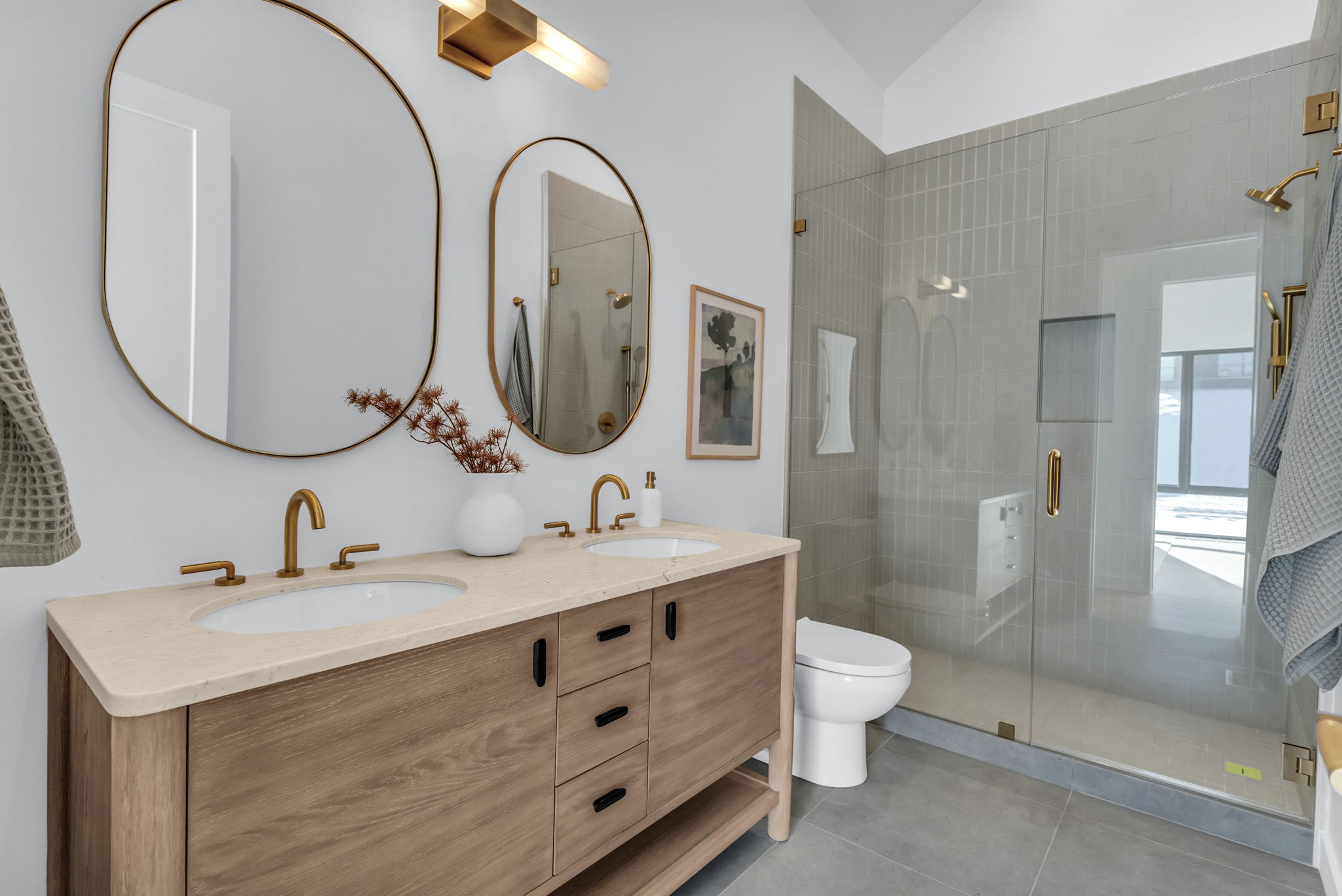 Dual vanity with wood-finish cabinetry and undermount sinks