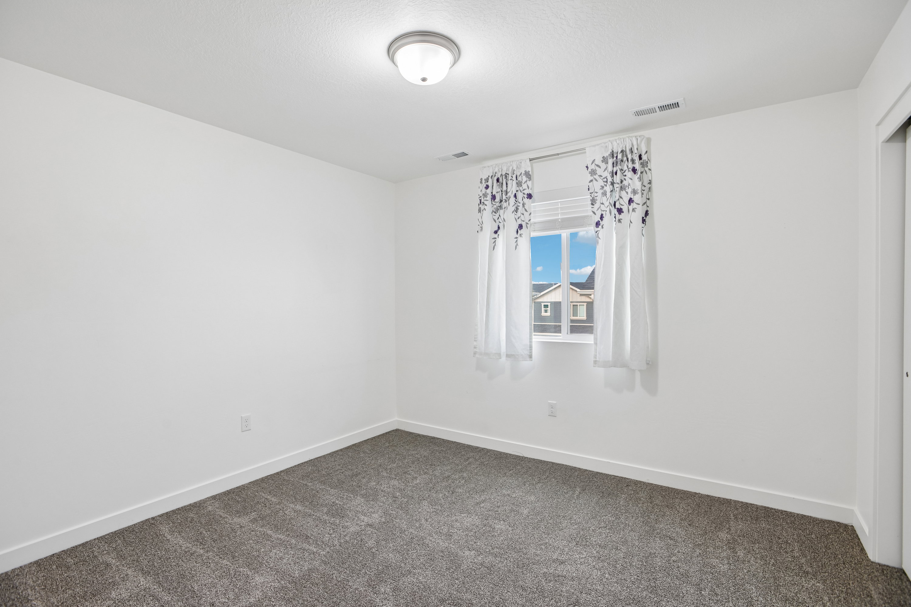 Neutral wall finishes with a window offering natural illumination
