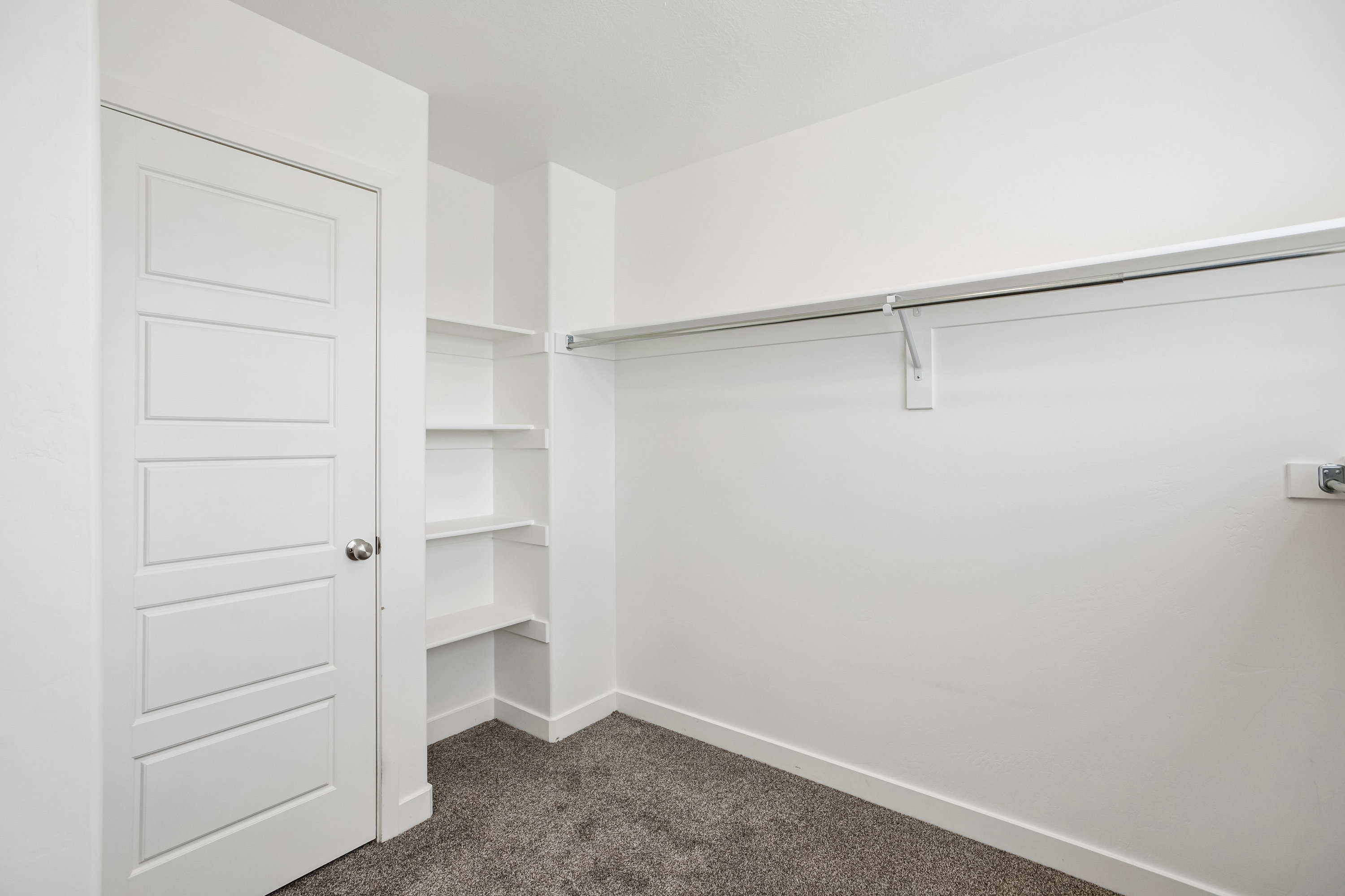 White interior door with contemporary paneling and chrome hardware