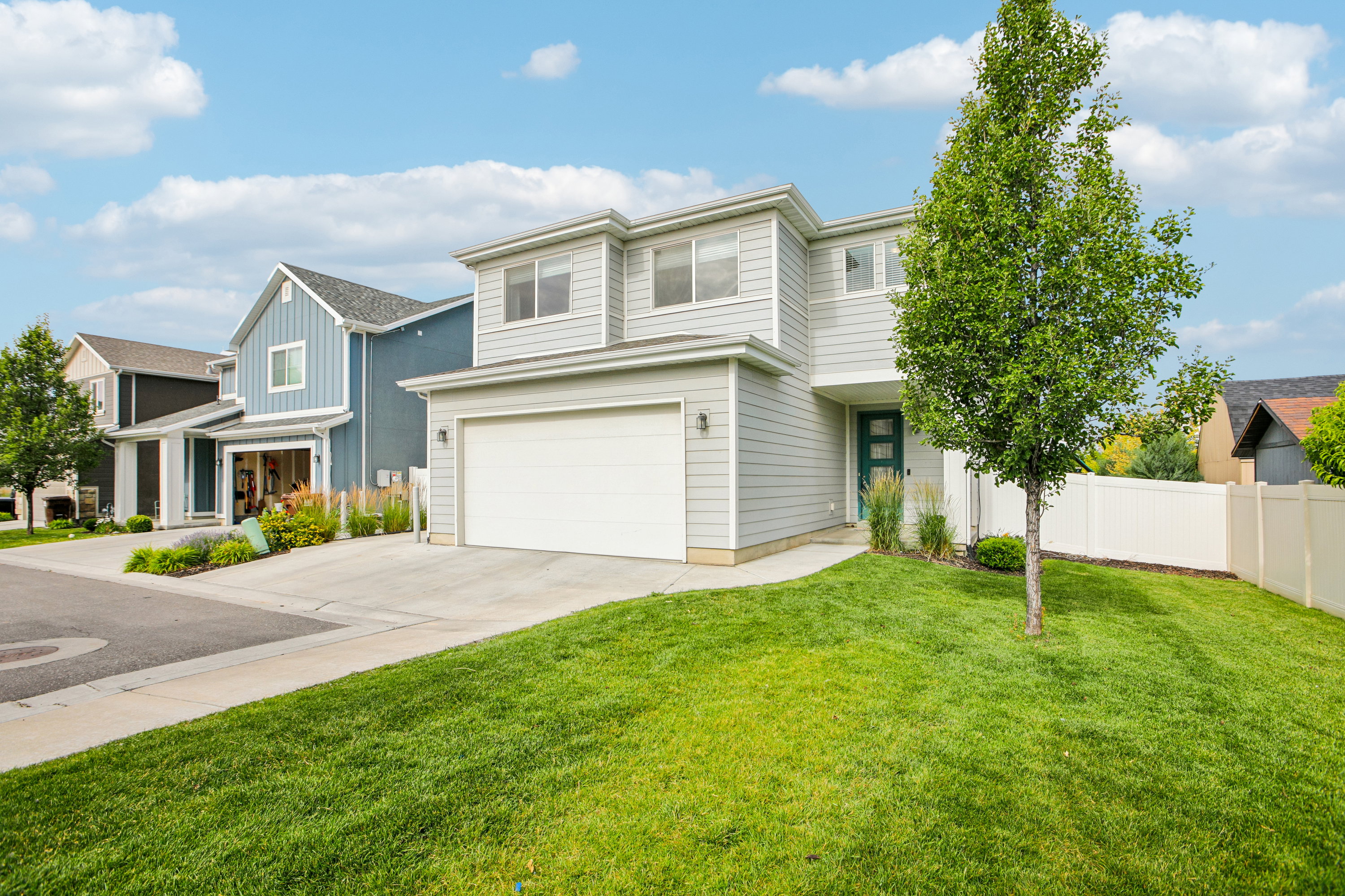 Contemporary two-story residence with light gray siding and white trim