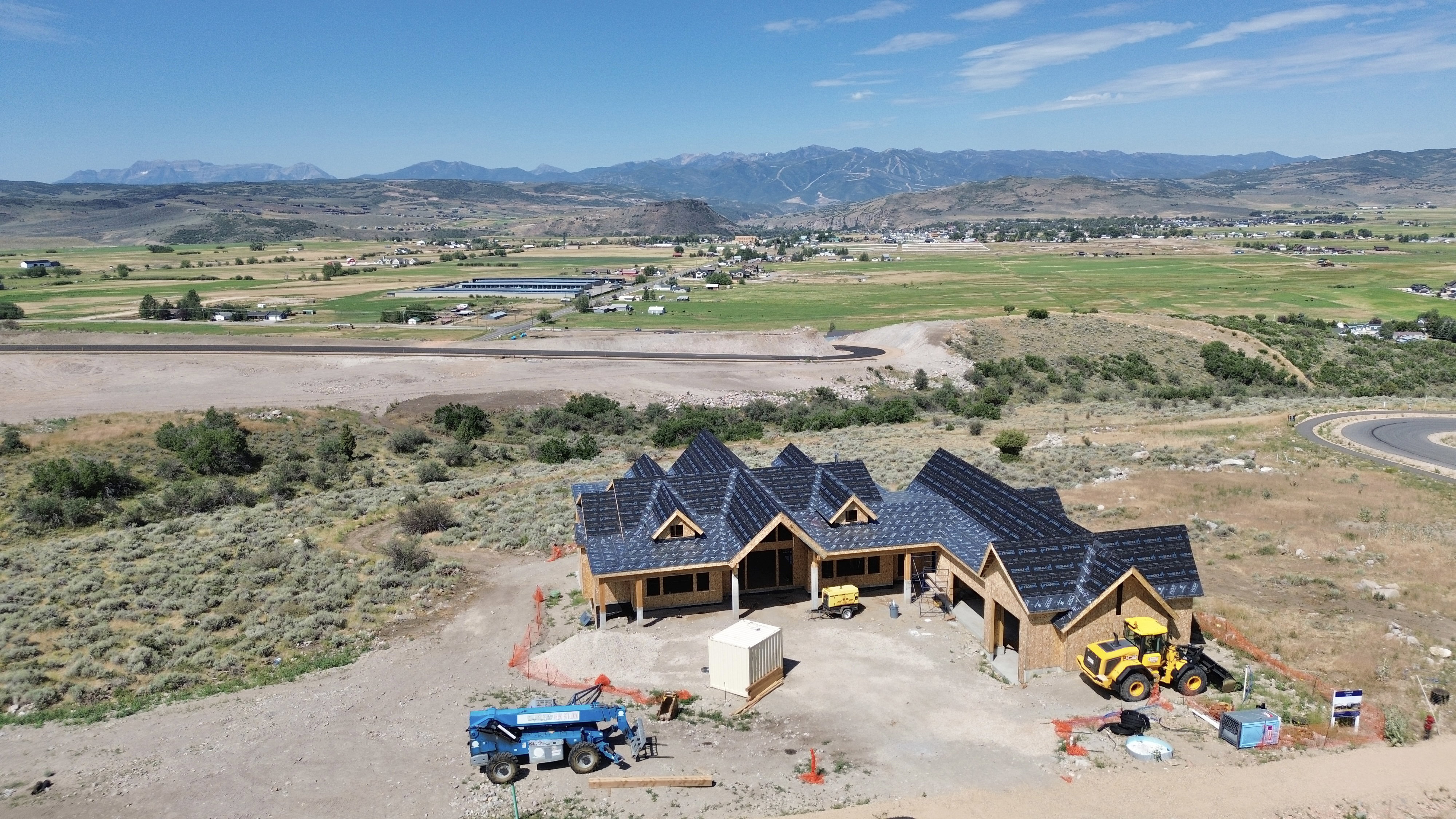 New construction with multiple gables and a dark shingle roof