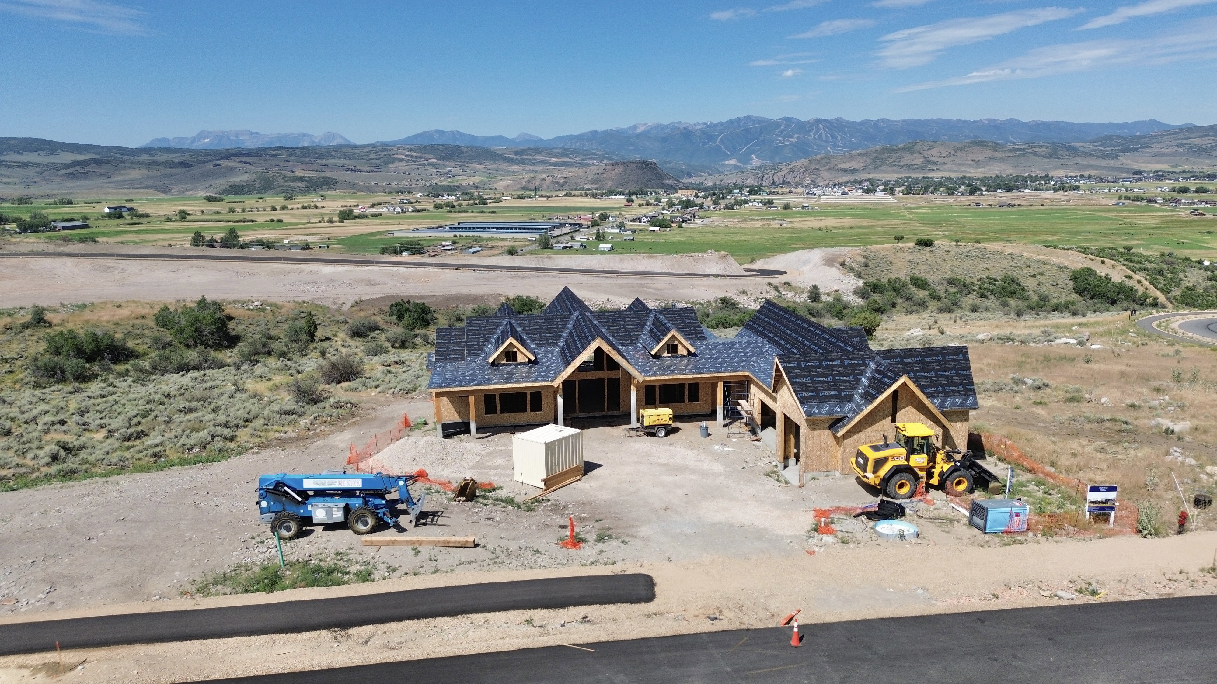 New construction residence featuring a multi-gabled roofline and framed exterior
