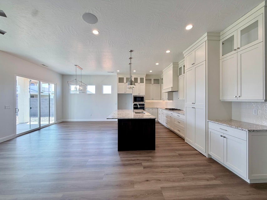 Open concept living space featuring wood-finish flooring, a contemporary kitchen, and a dining area