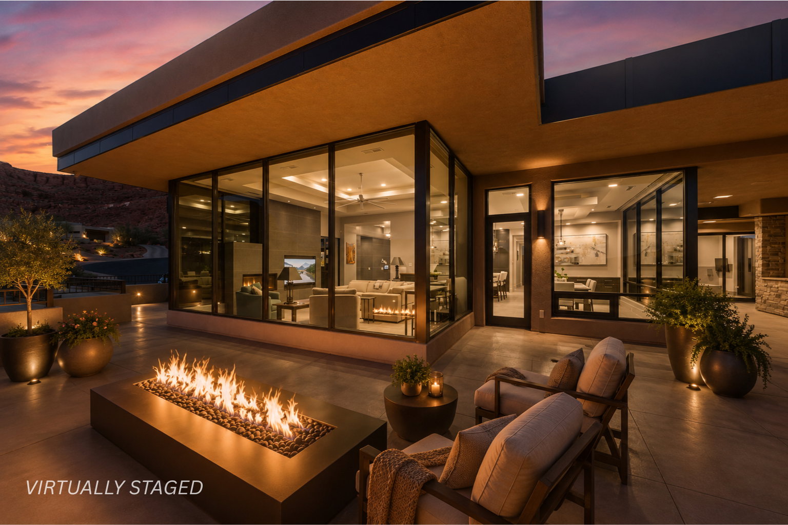 Spacious outdoor patio featuring a linear fire pit, large format tile flooring, and integrated landscape lighting