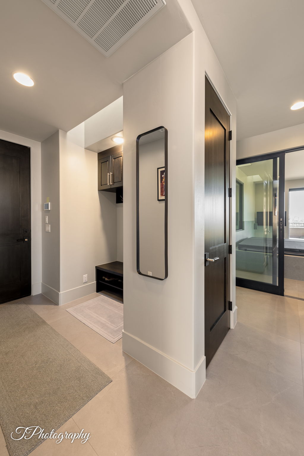 Entryway featuring recessed lighting, light-toned tile flooring, and dark wood-finish doors