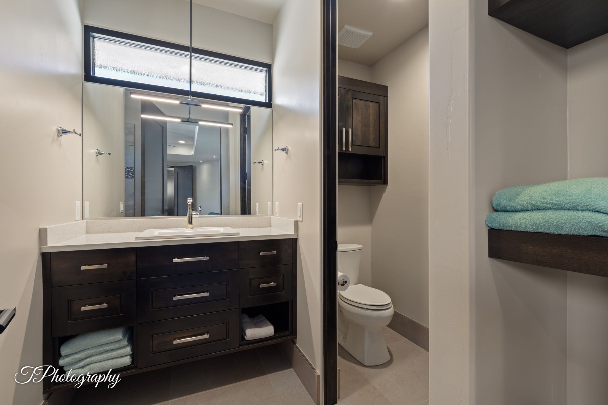 Floating vanity with a light-colored countertop and an undermount sink