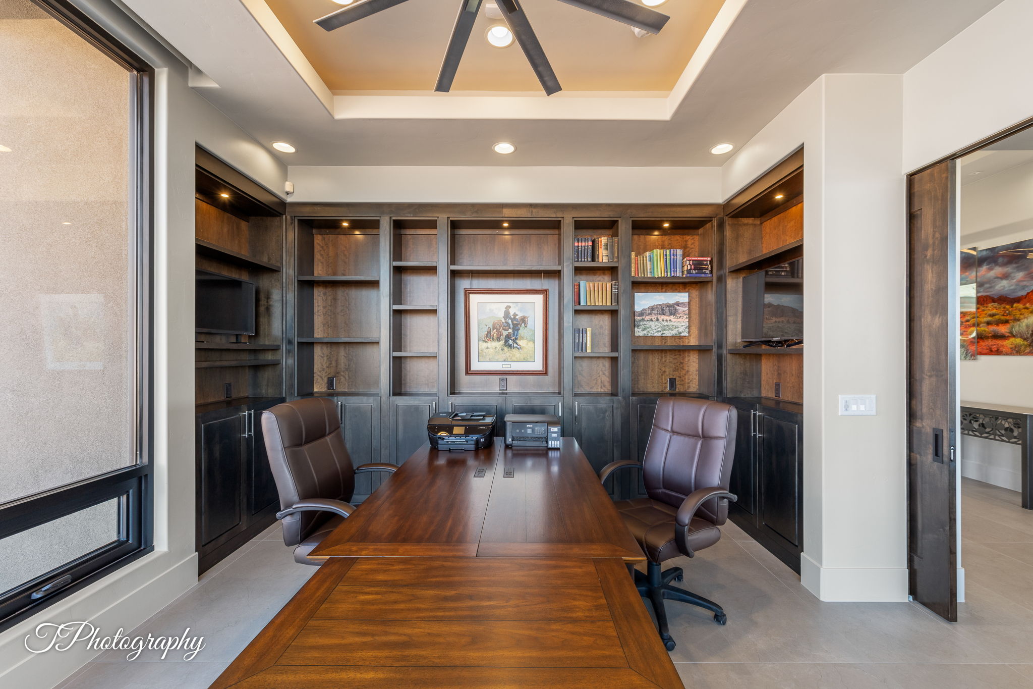 Office space featuring extensive built-in shelving, integrated cabinetry, and recessed lighting