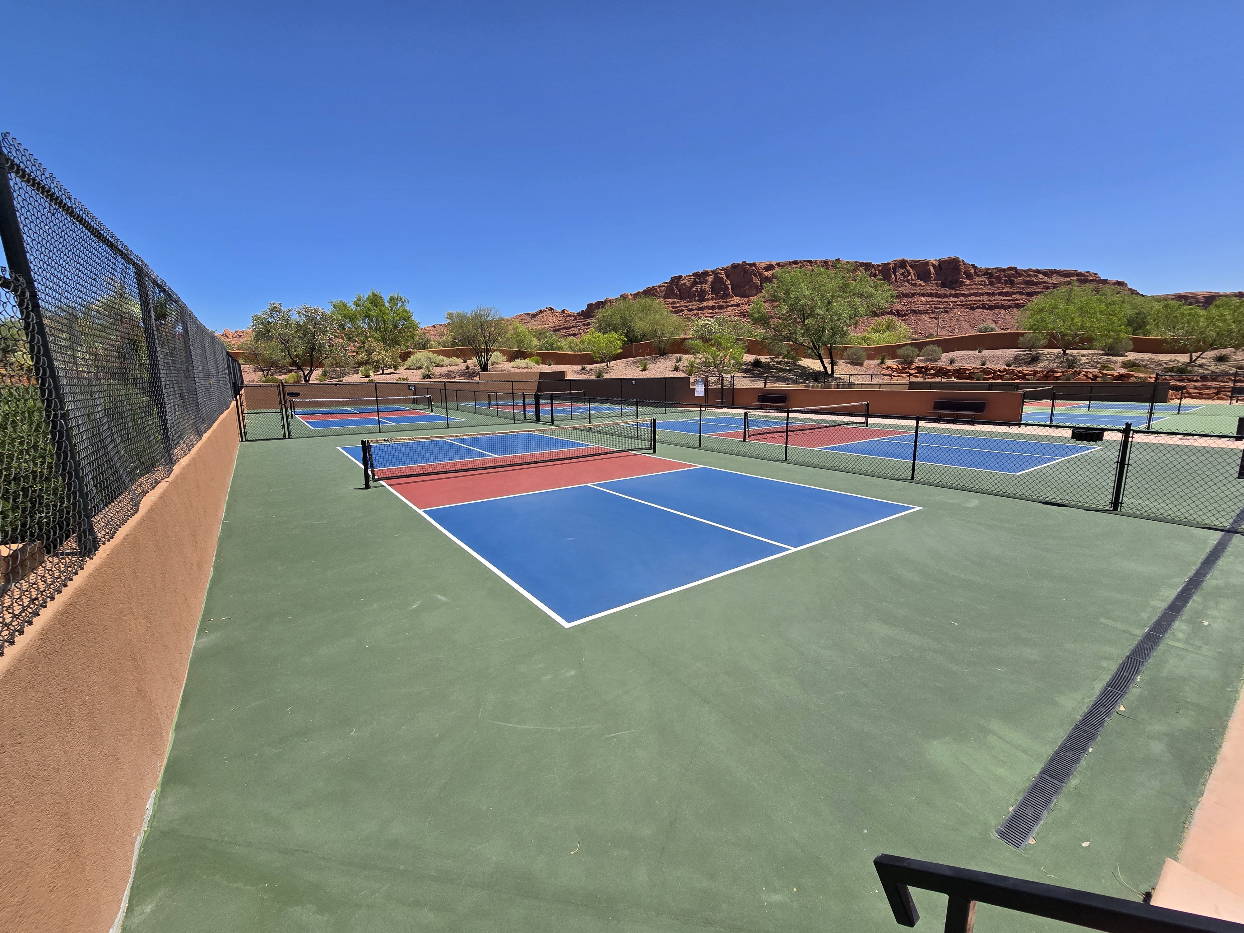 Multiple outdoor courts featuring green, blue, and red playing surfaces