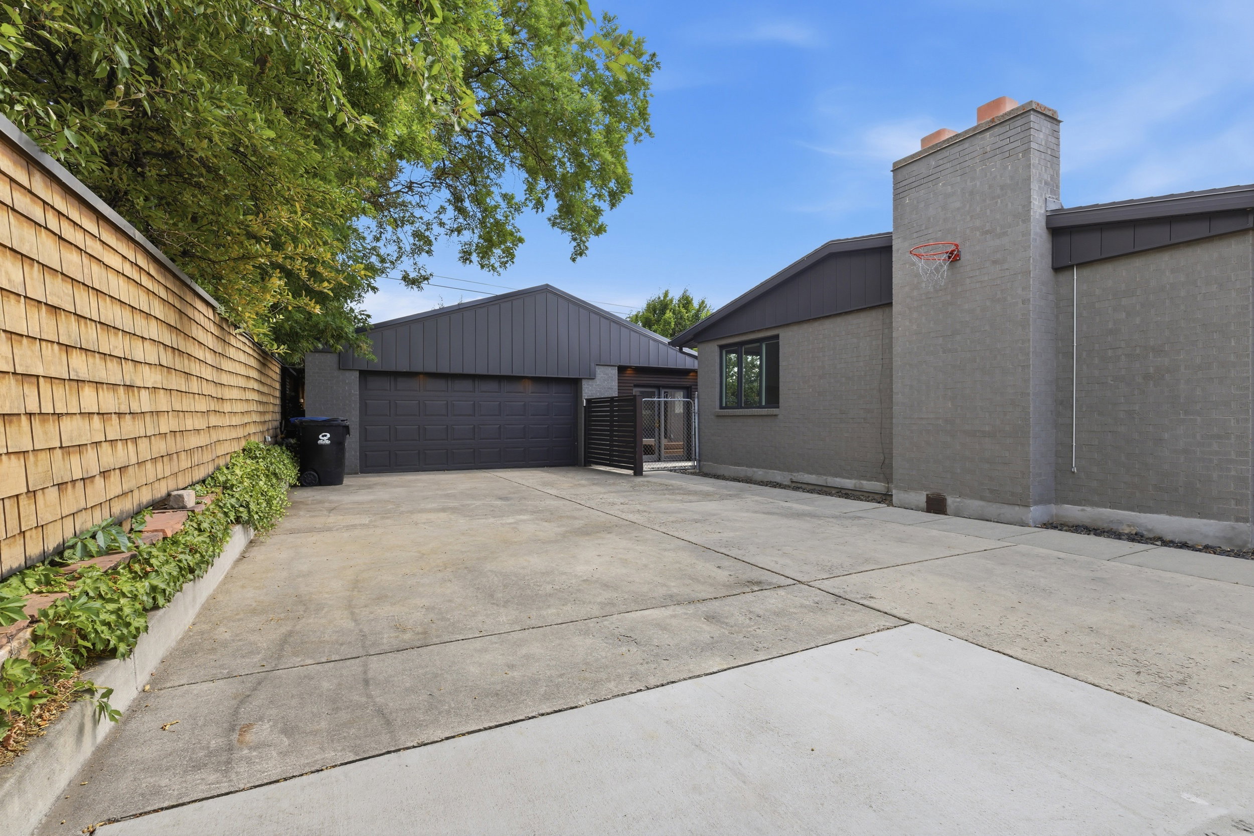 Concrete driveway leading to a two-car garage with a dark paneled door