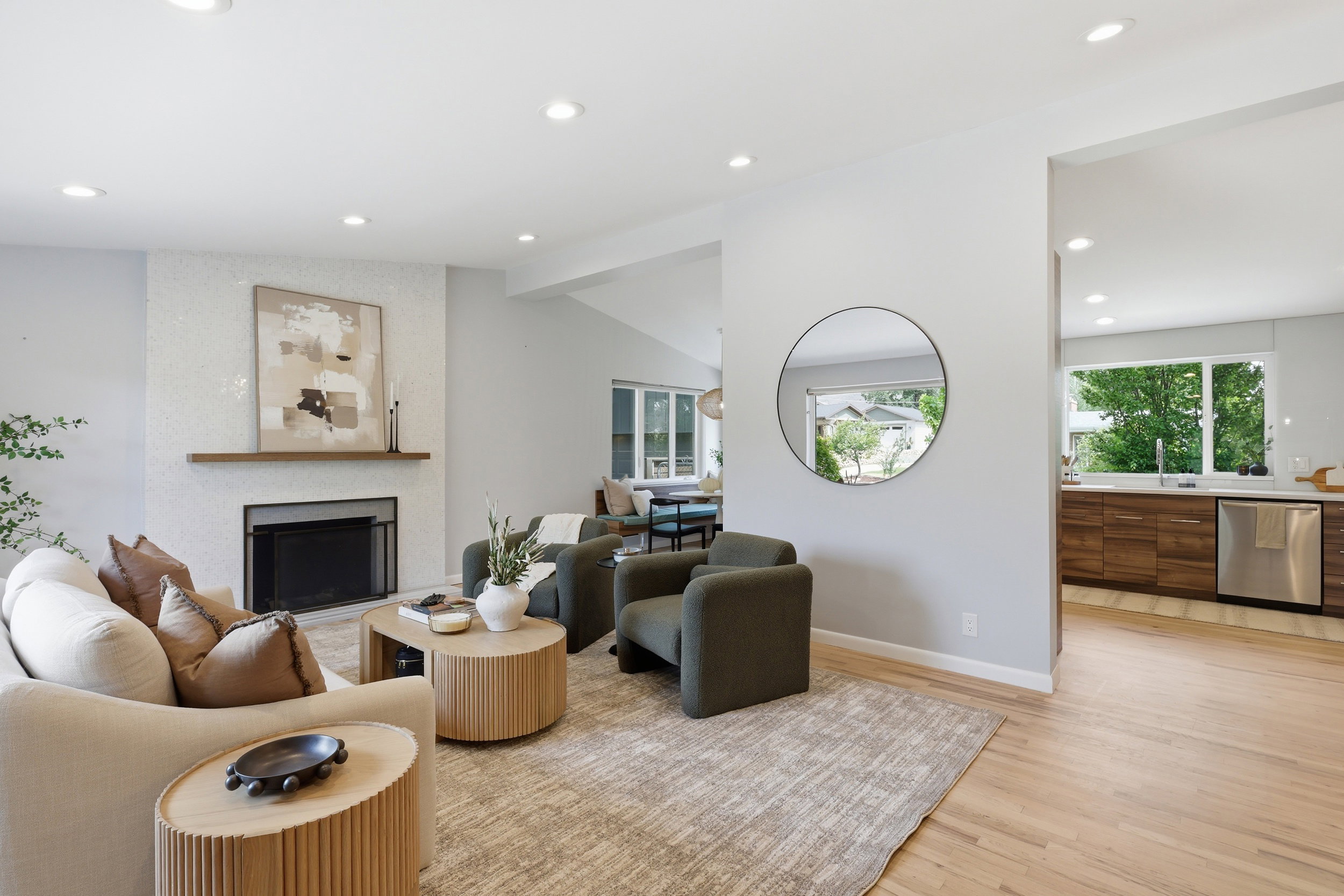 Living area with a fireplace featuring a tiled surround and wood mantel