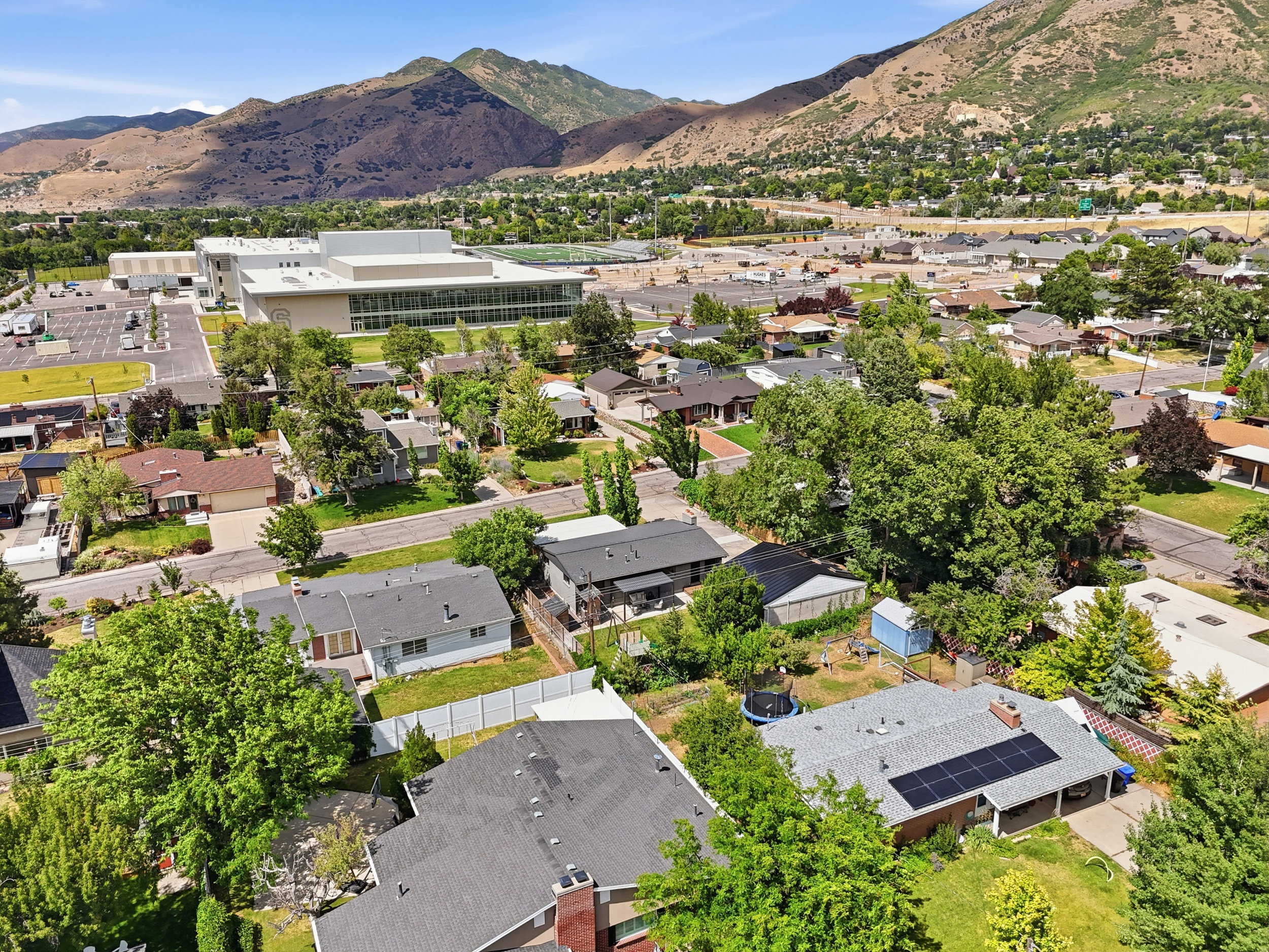 Aerial perspective showcasing residential properties with a mountainous backdrop