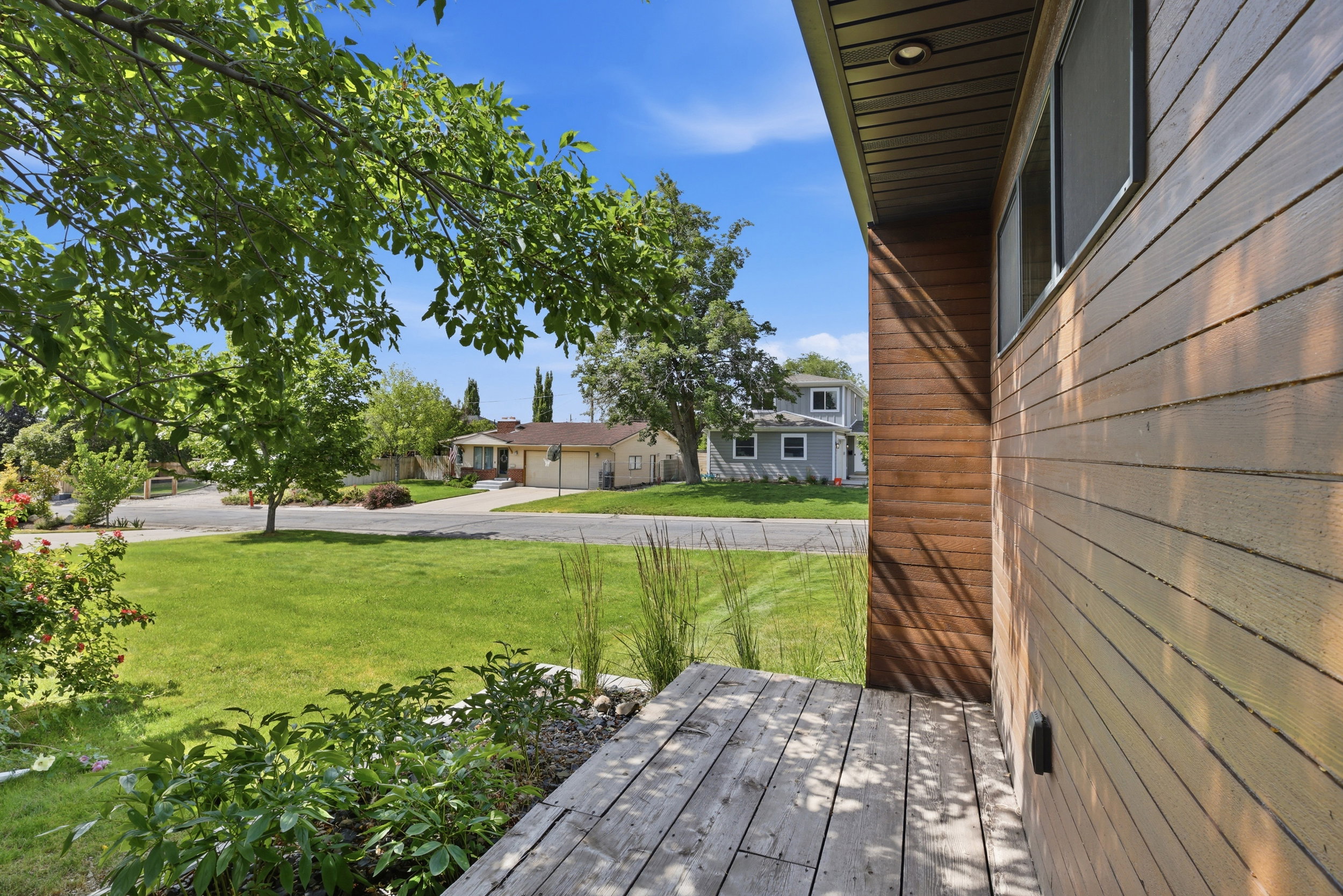 Contemporary wood-style siding with horizontal panels and a darker wood accent column