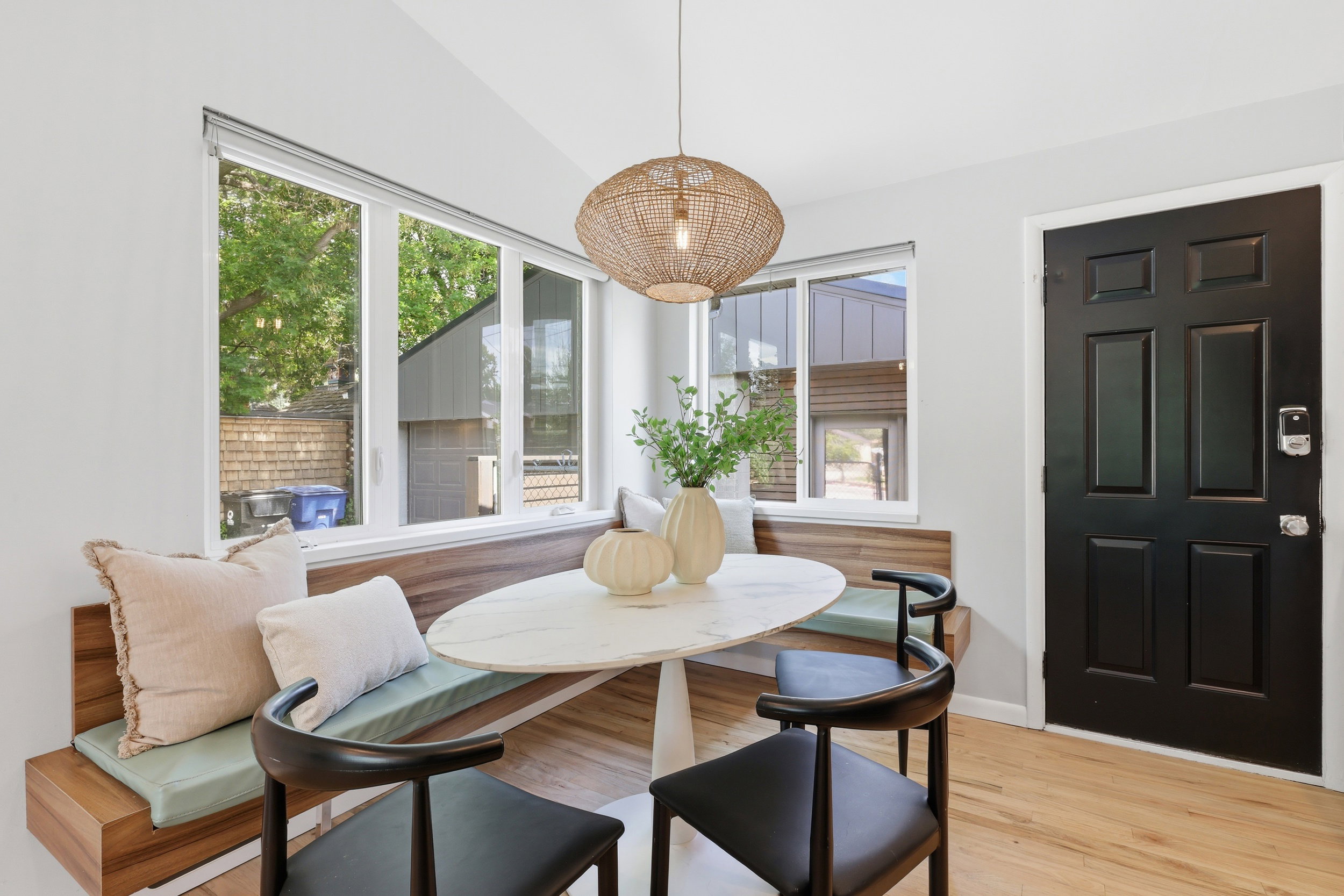Built-in wood-finish bench seating with light green cushions