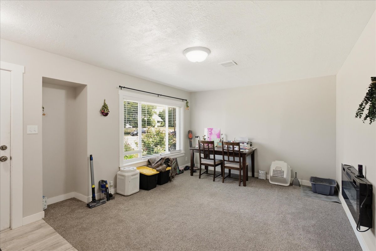 Light gray carpeting and neutral wall tones create a versatile interior space