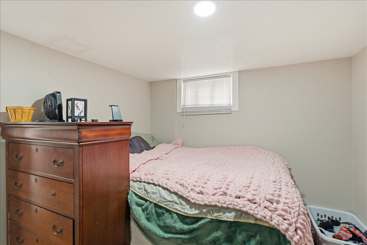 Neutral-toned walls complement the white trim around the window, featuring horizontal blinds for controlled light