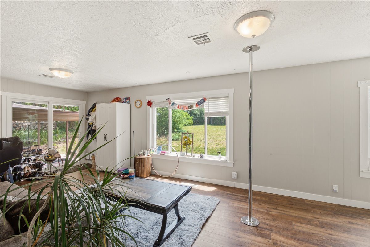 Bright living space featuring wood-finish flooring and neutral wall tones