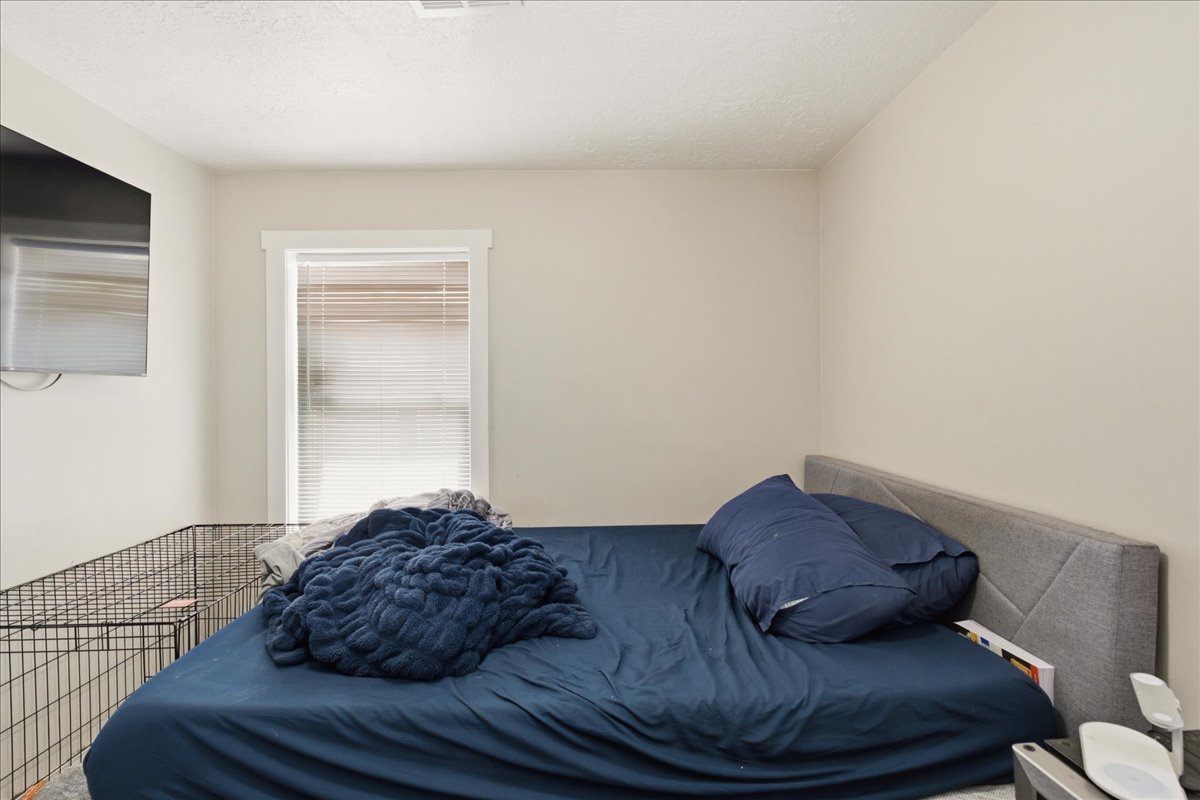 Neutral wall paint, a single window with blinds, and white trim work