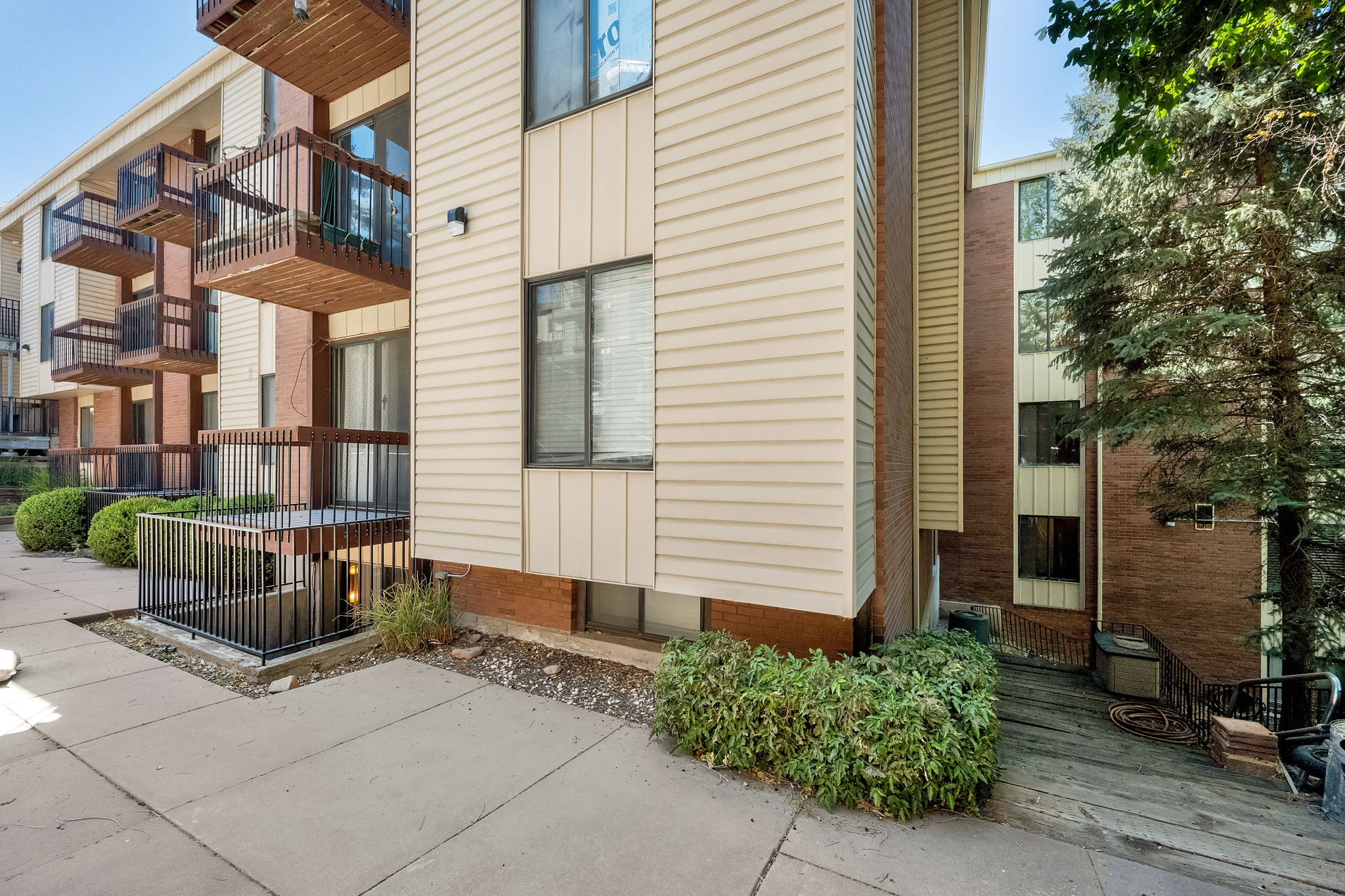 Multi-story building exterior featuring vertical siding and brickwork
