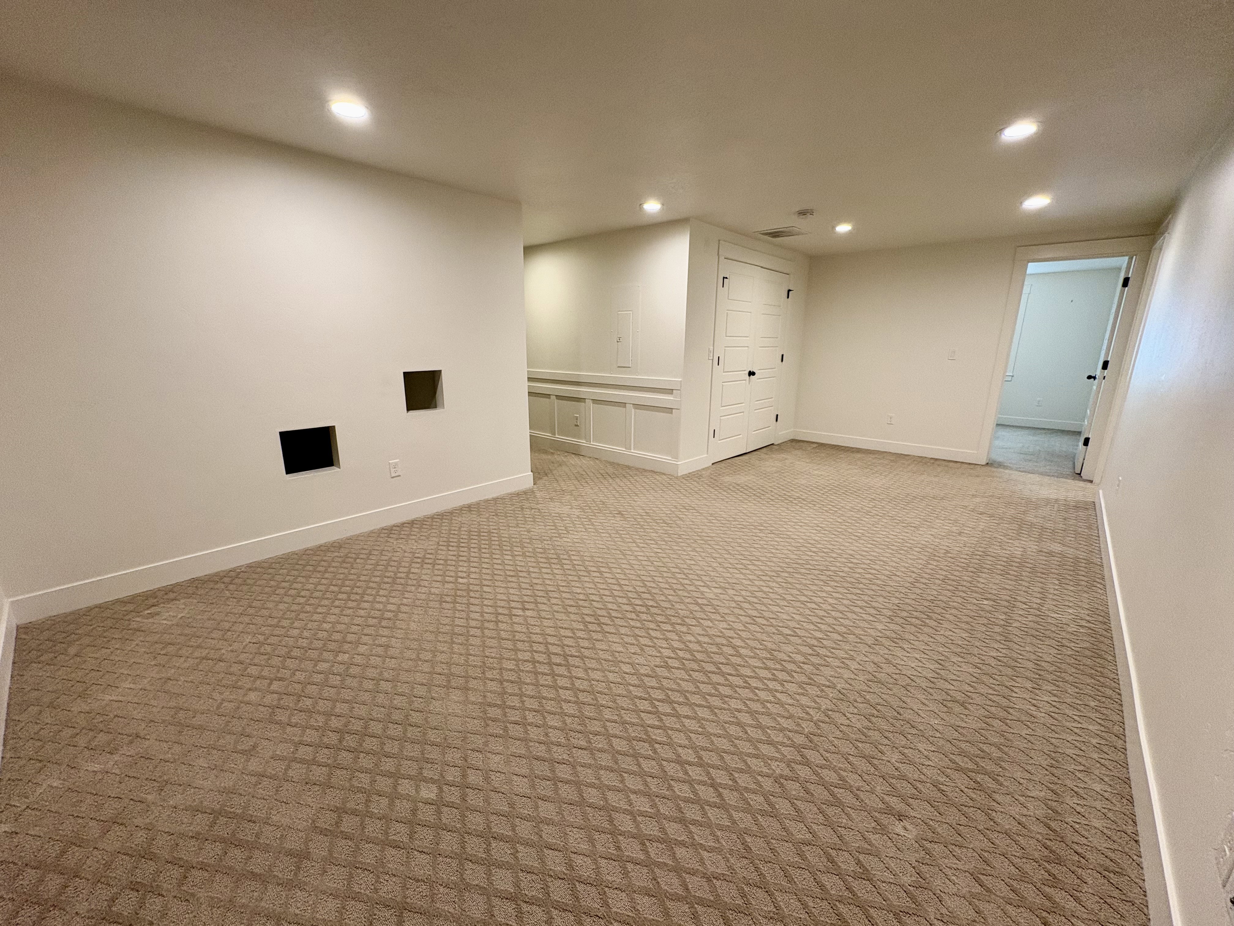 Spacious Family room featuring patterned carpeting and recessed lighting