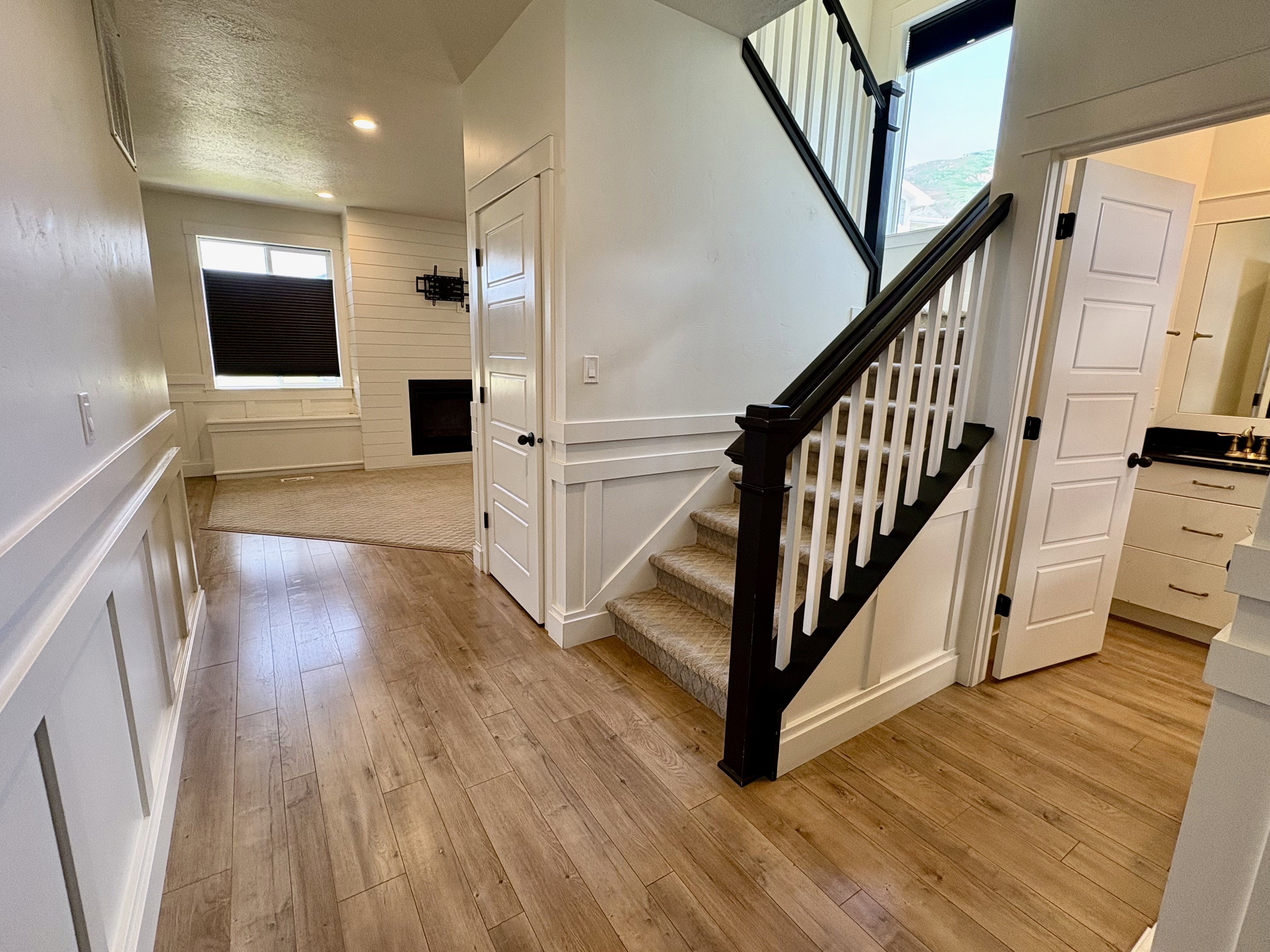 Light wood-finish flooring extending through the entry hall