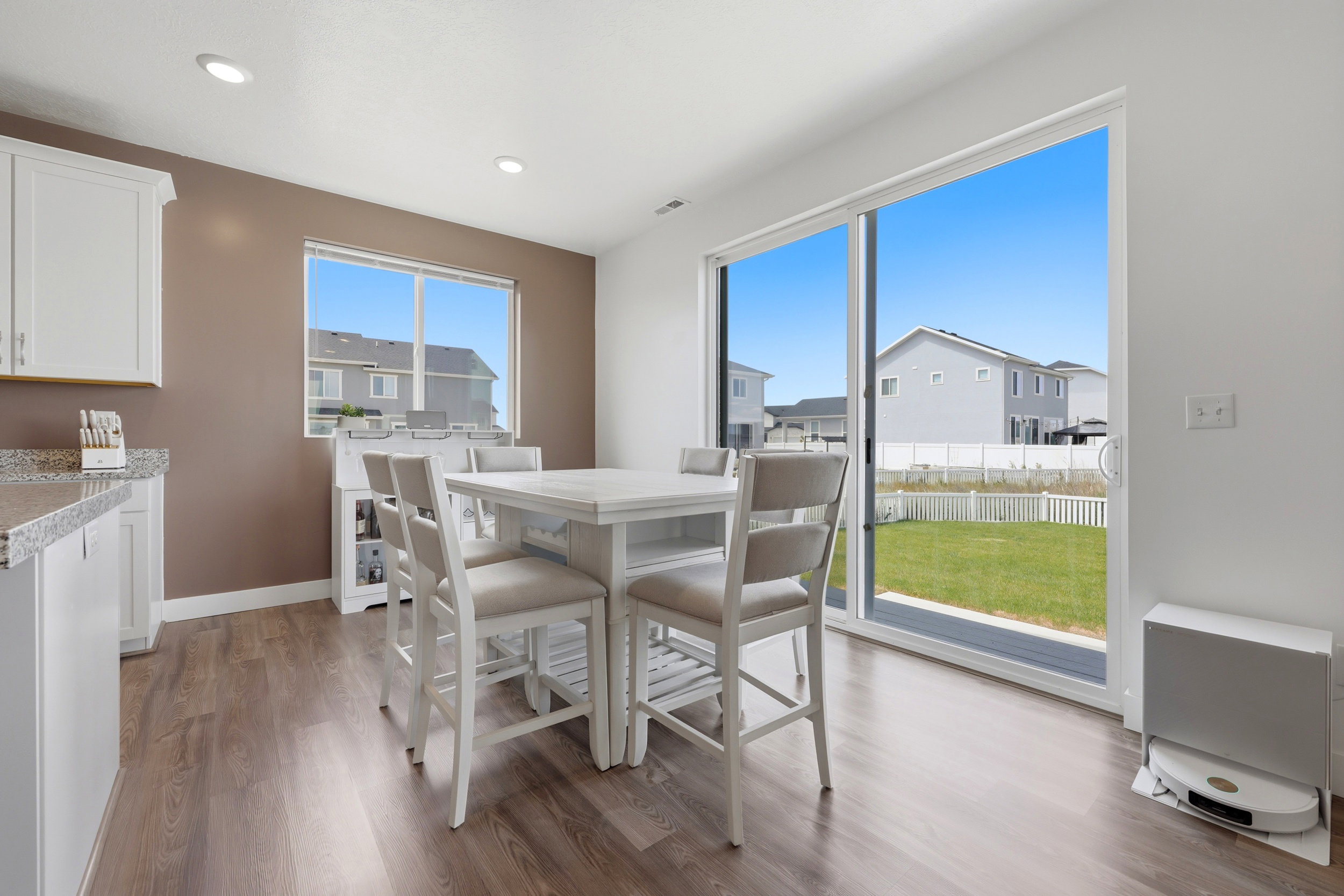 Dining area featuring wood-finish flooring, recessed lighting, and a large window