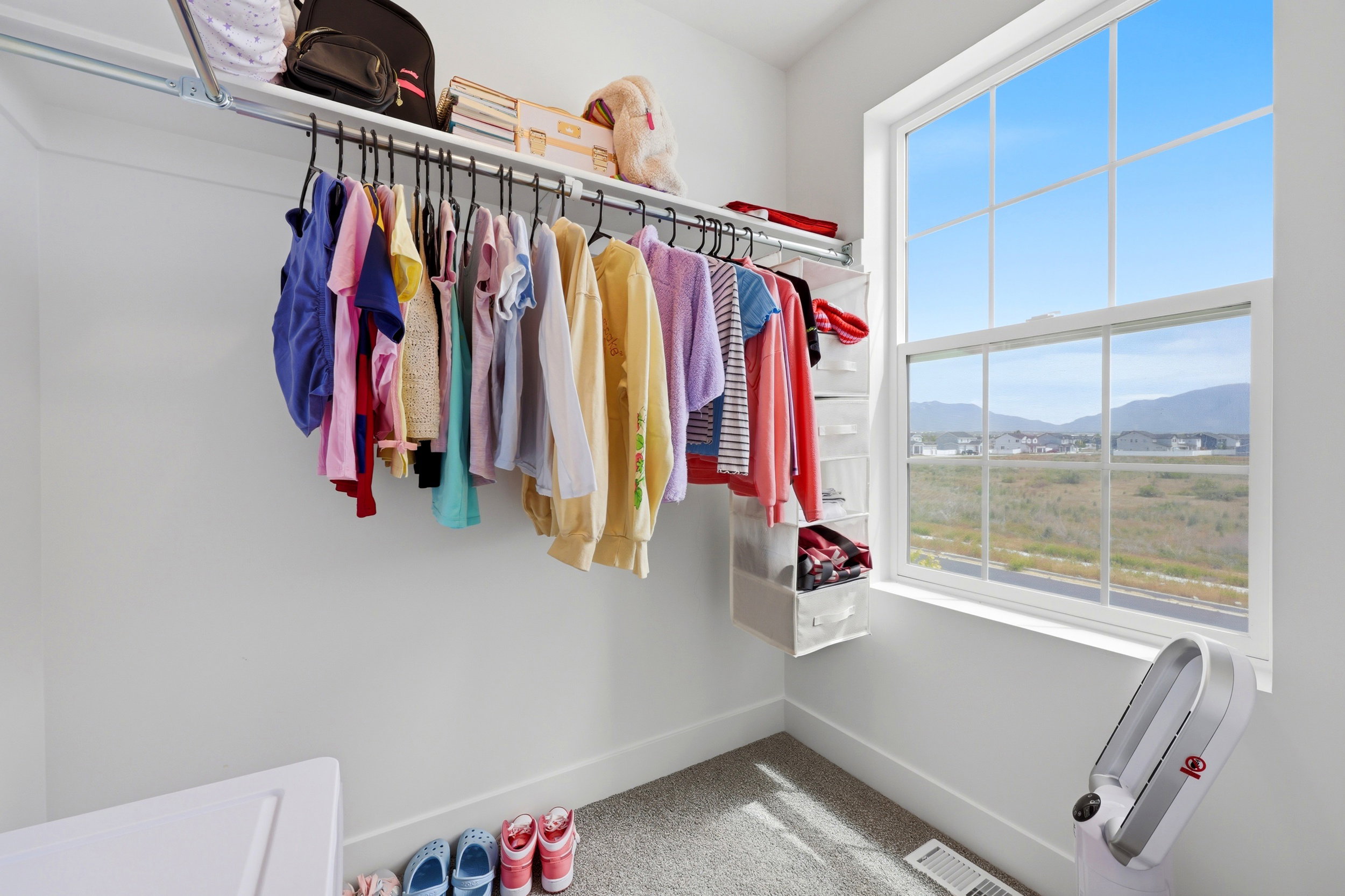 Built-in closet system featuring upper shelving and hanging rod storage