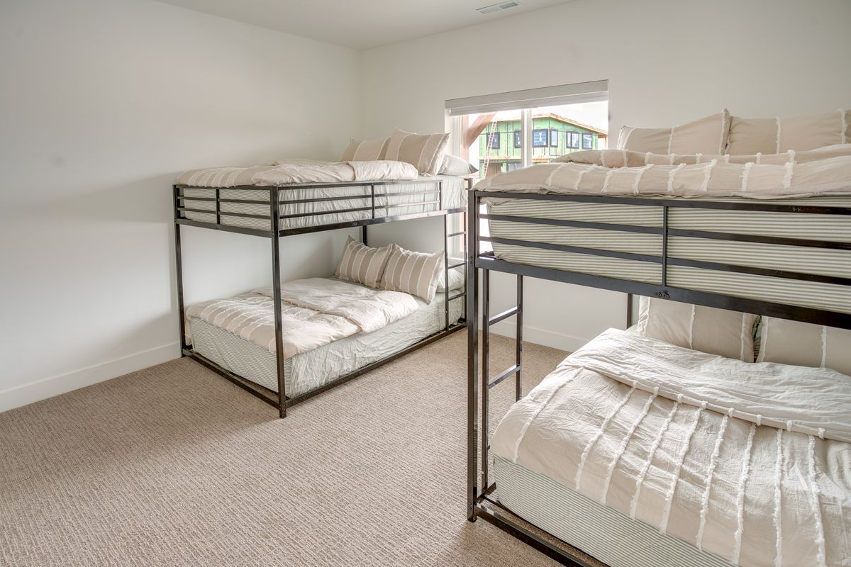 Bright room featuring neutral-toned carpet flooring and white walls