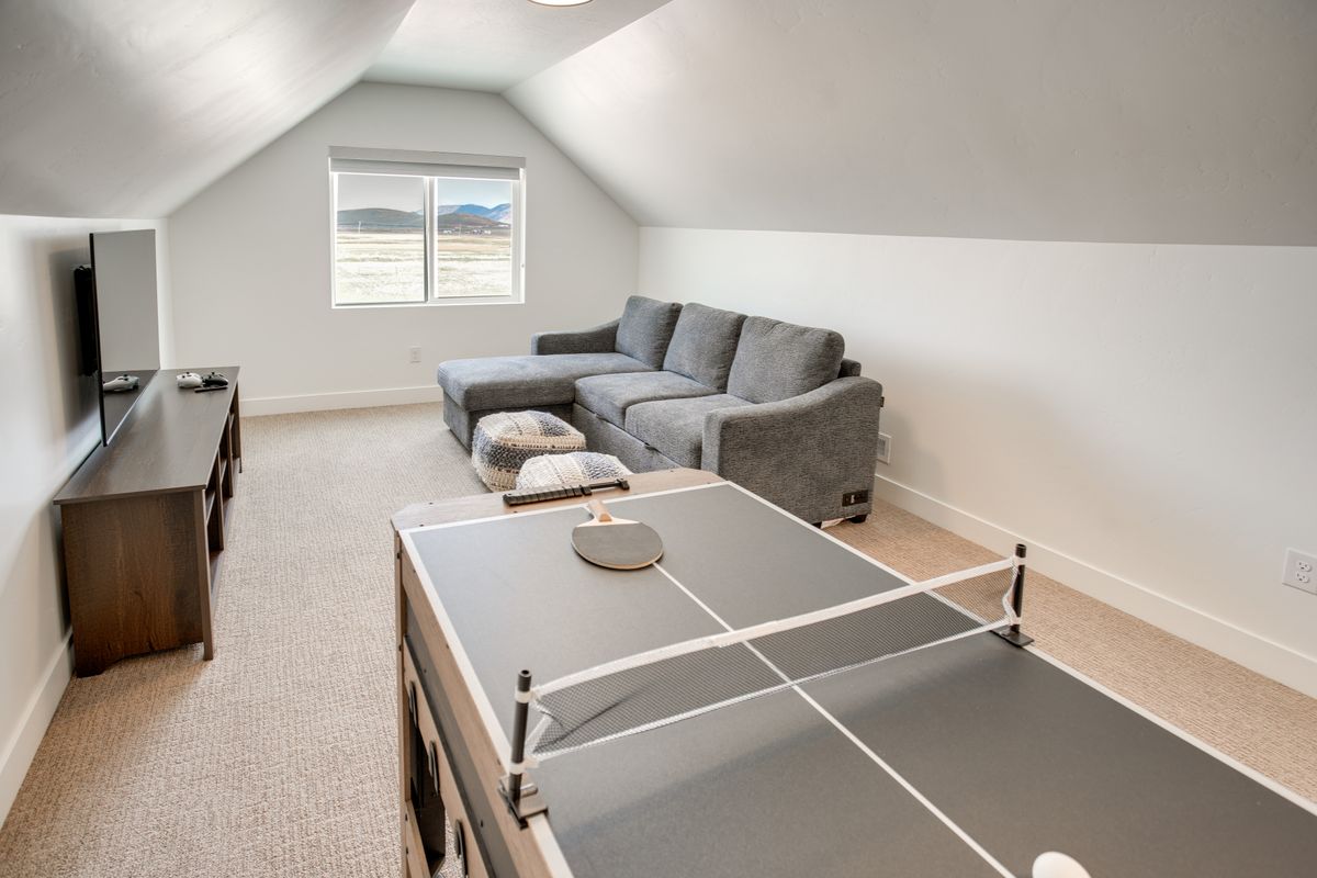 Attic bonus room featuring sloped ceilings, recessed lighting, and light-colored carpeting