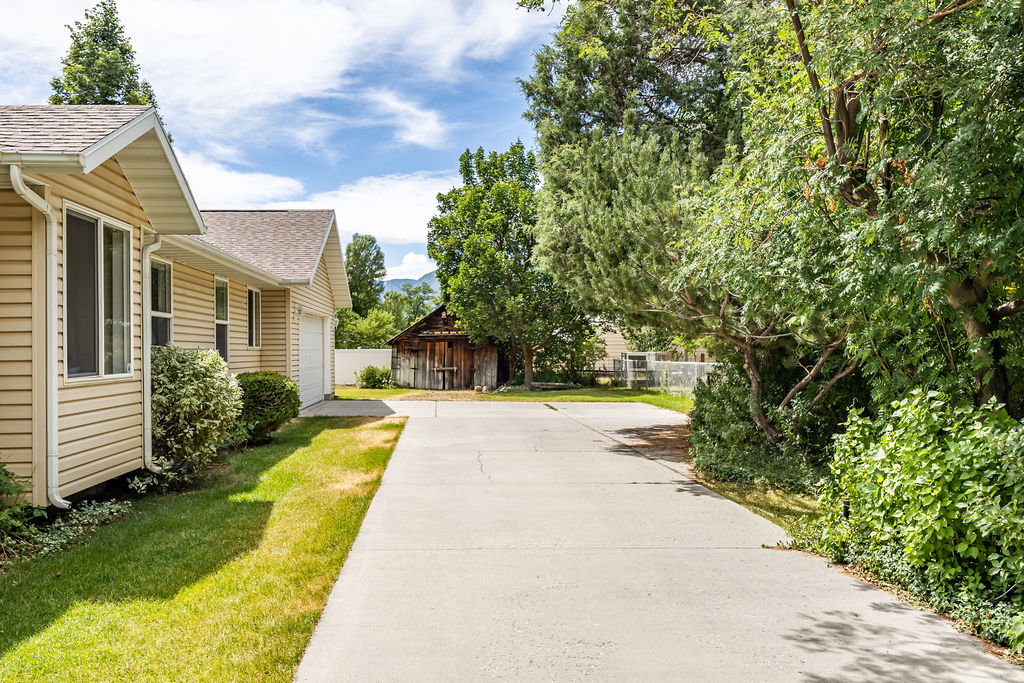 Long concrete driveway and attached garage with plenty of room to pull out and drive forward