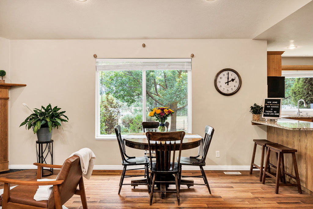 Open concept dining space with wood-finish flooring
