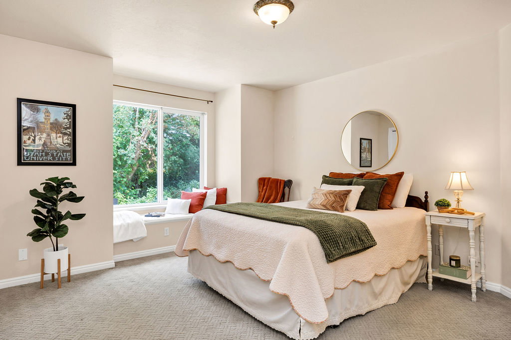 Spacious 2nd bedroom featuring a wide window seat with storage beneath, neutral wall color, recessed lighting, and patterned carpet flooring