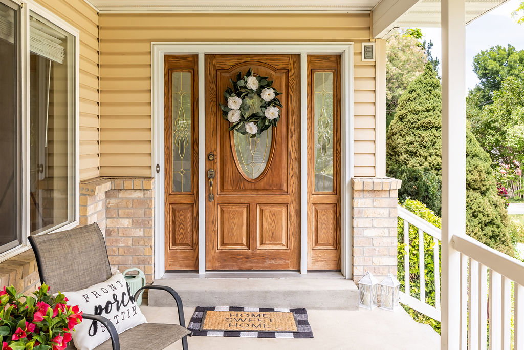 Front entry featuring a wood-panel door with oval leaded glass, flanked by two sidelight windows