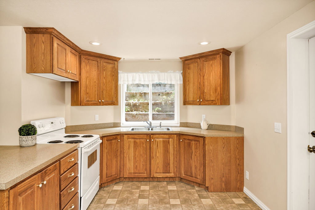 Kitchen featuring wood-finish cabinetry and another lovely floral terraced window well