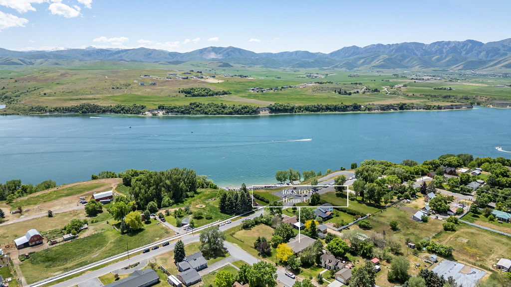 Expansive aerial perspective Hyrum Reservoir bordered by green landscapes and the Wellsvilles
