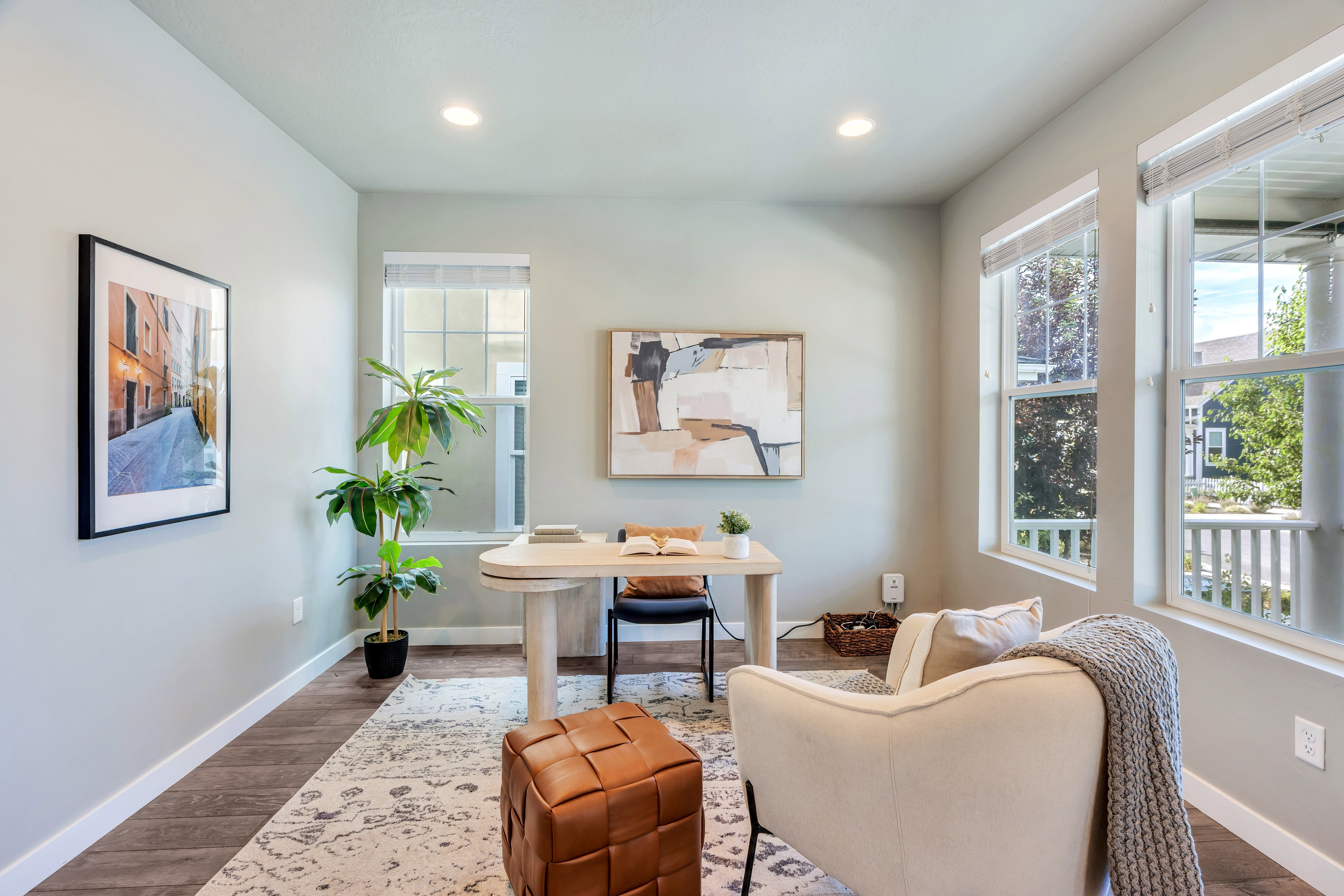 Bright room featuring wood-finish flooring, recessed lighting, and multiple windows