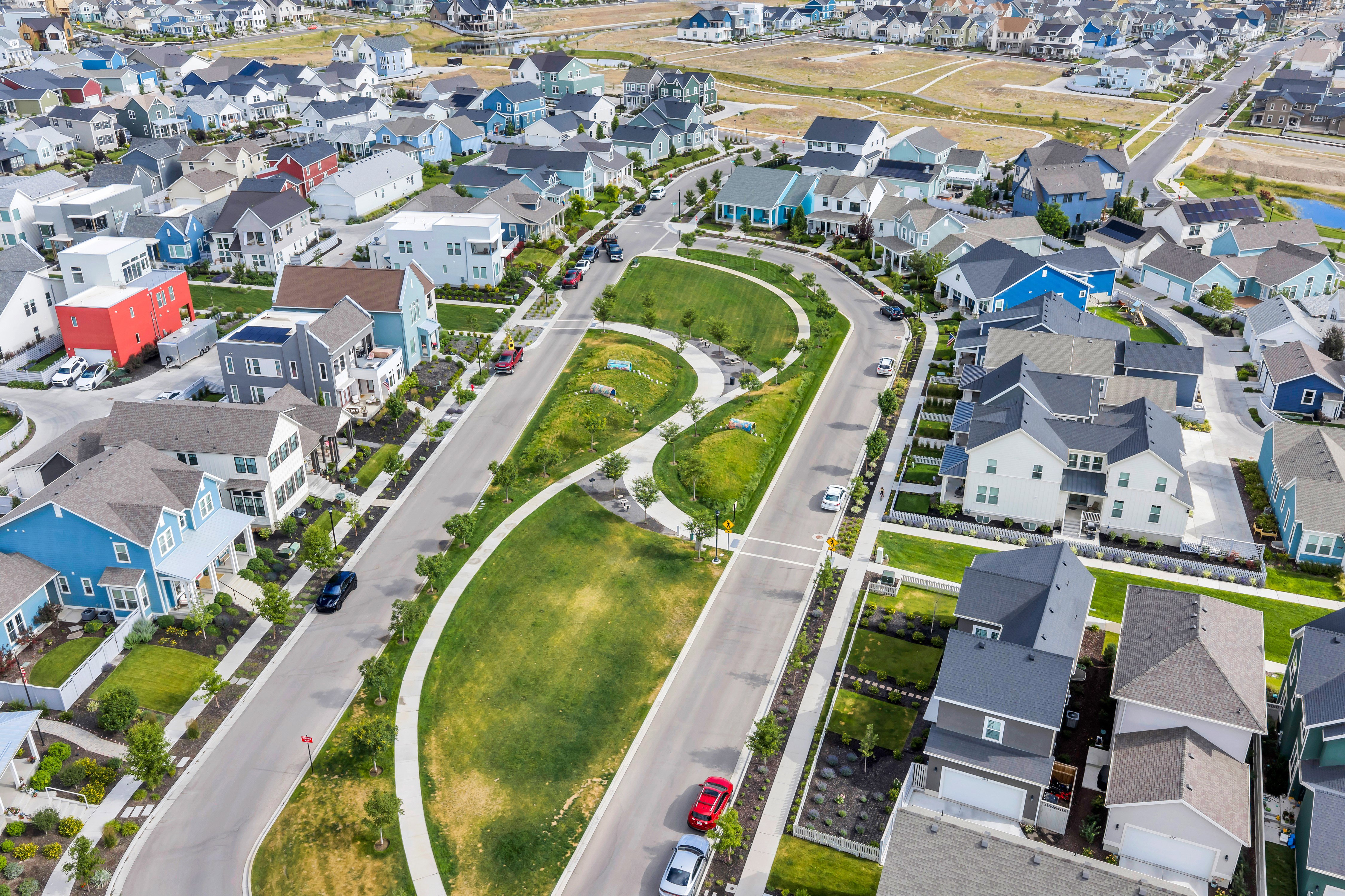 Expansive aerial perspective showcasing a residential community with varied architectural styles