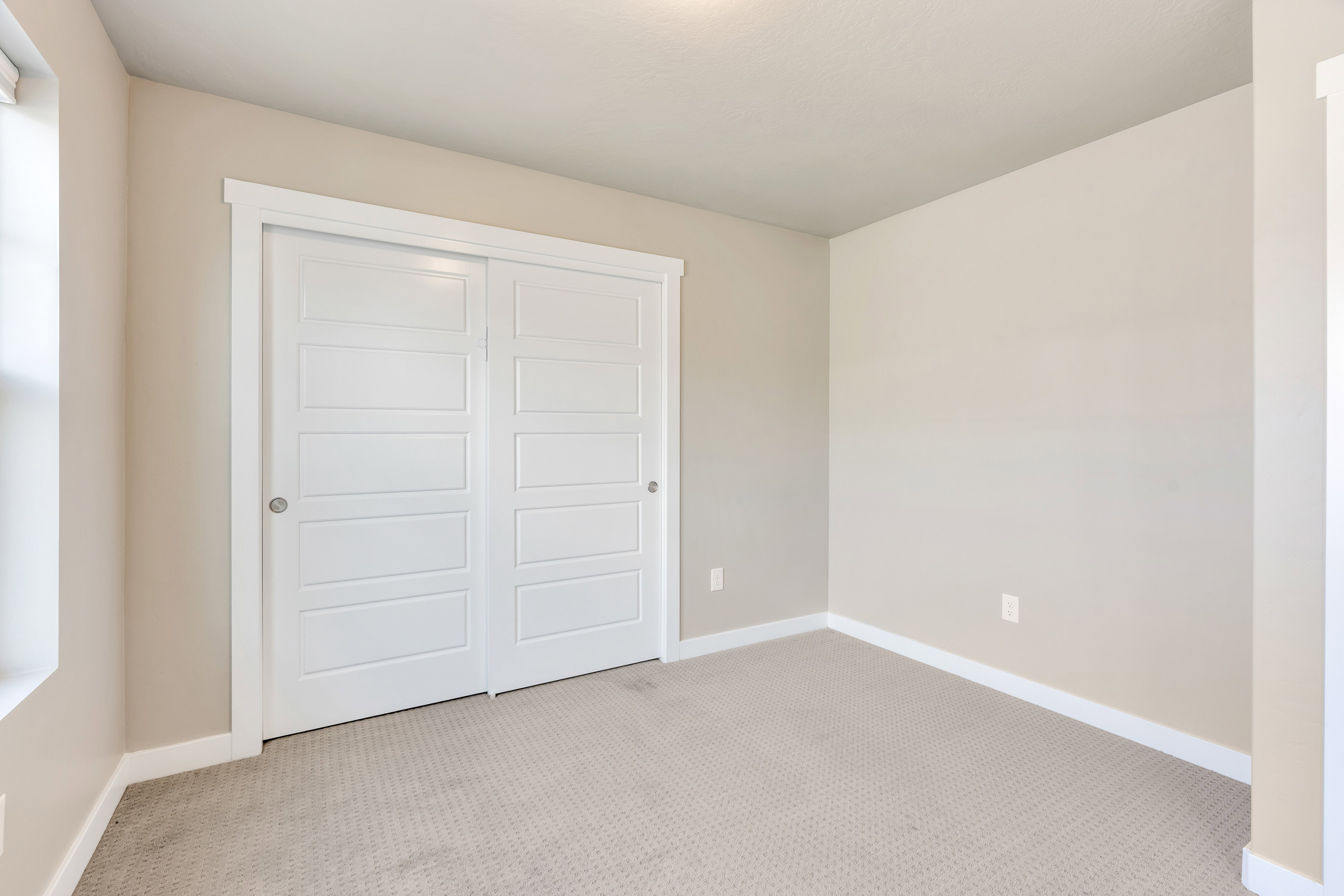 Bedroom featuring light neutral wall paint, white trim, recessed lighting, patterned carpet flooring, and a window with white trim