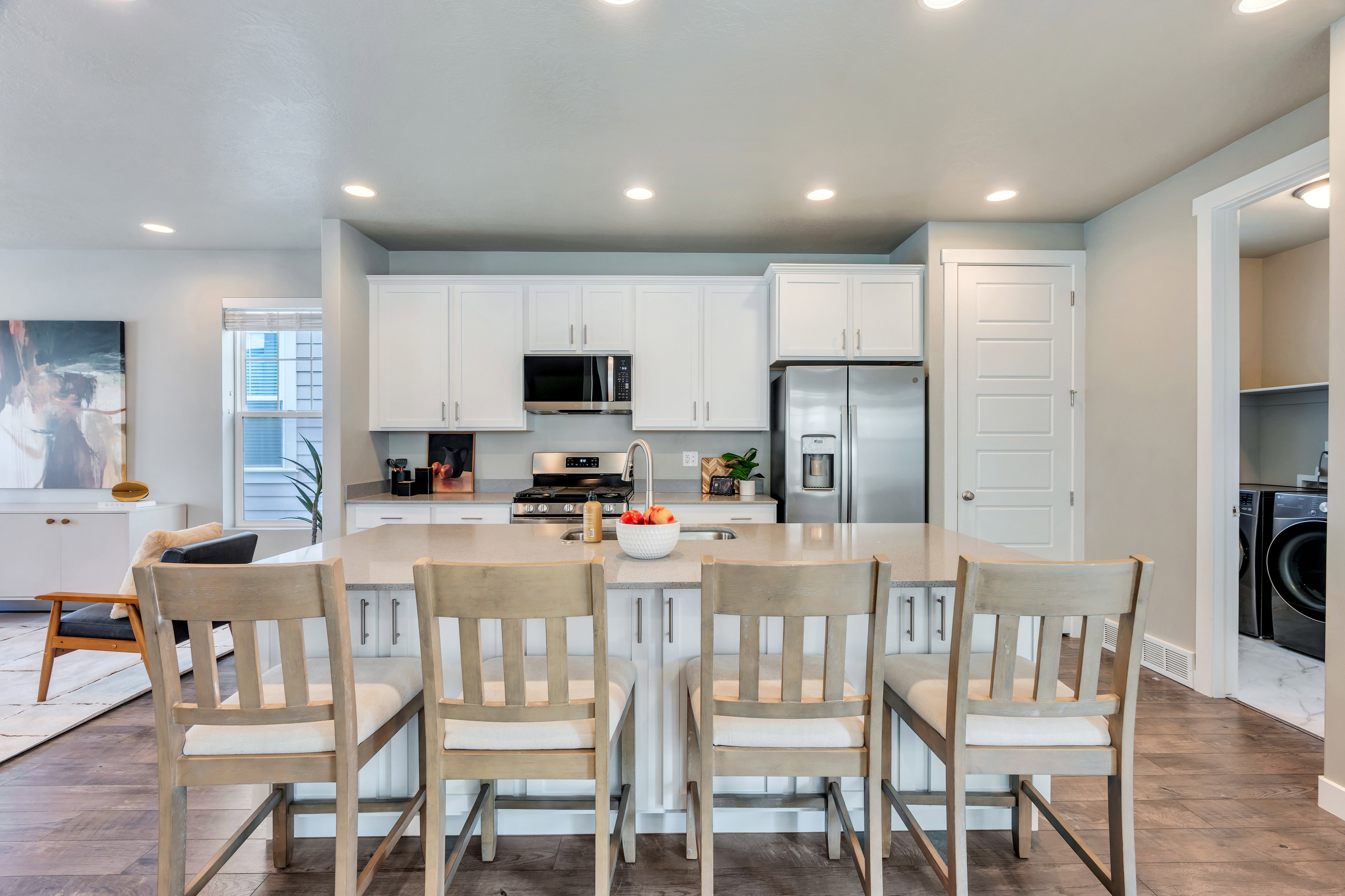 Kitchen island with light-toned countertop and integrated sink