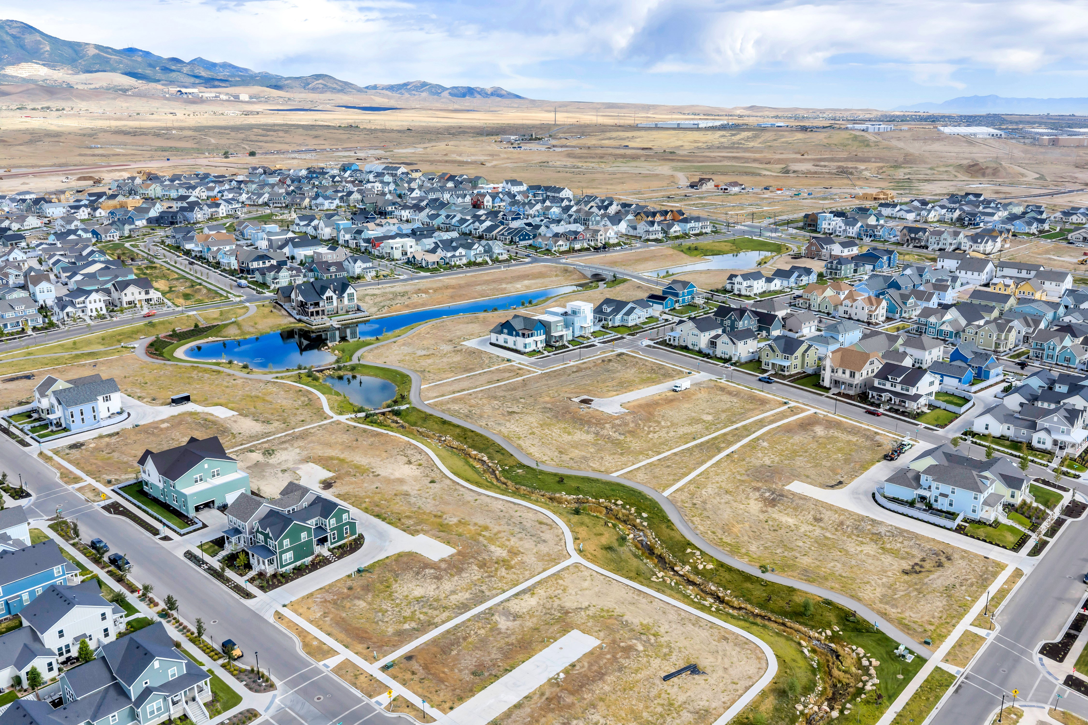 Aerial perspective showcasing a developing residential community with constructed homes and available land parcels