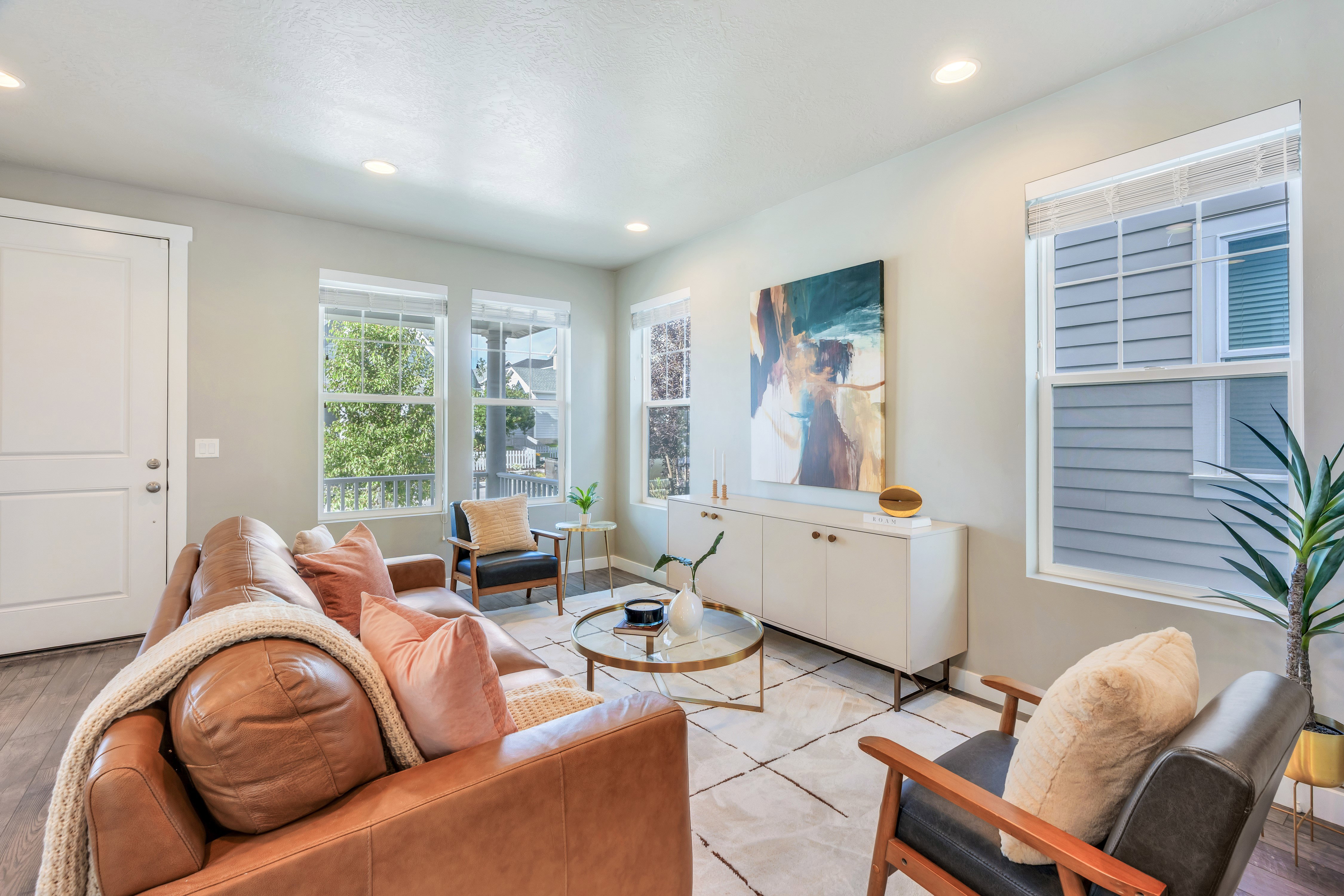 Bright living space featuring recessed lighting and wood-finish flooring