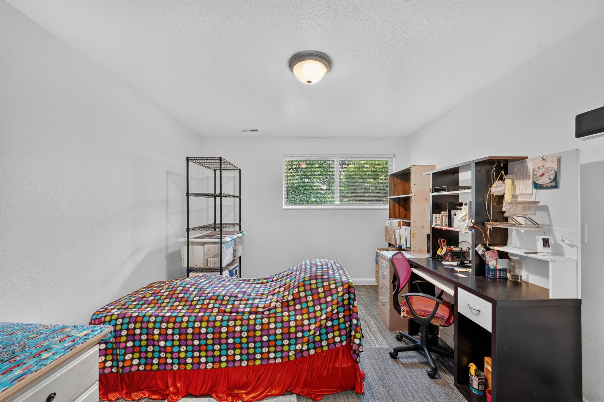 Recessed window offering natural light, wood-finish flooring, and neutral wall tones