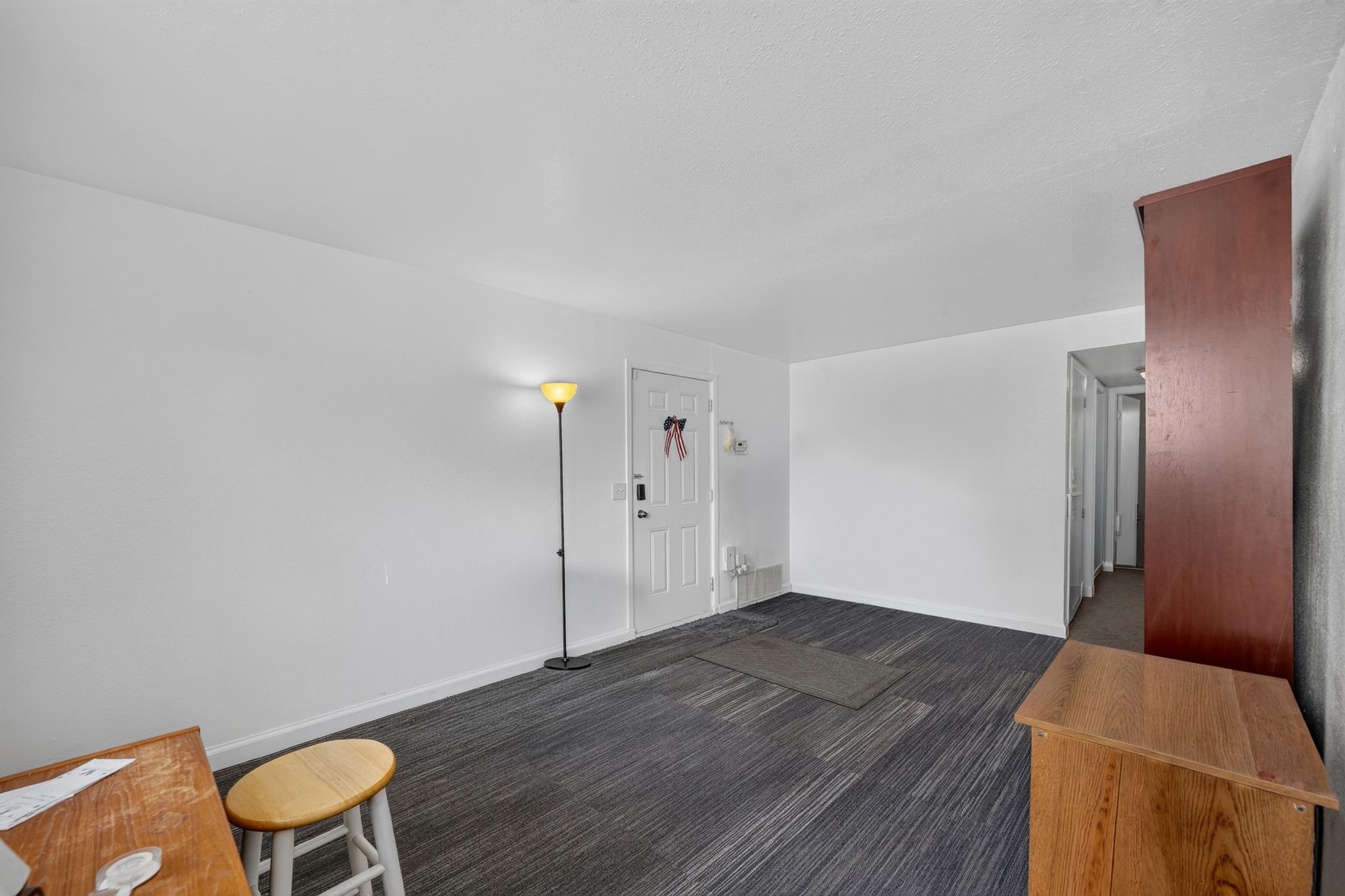 Spacious room with dark-toned patterned carpet flooring