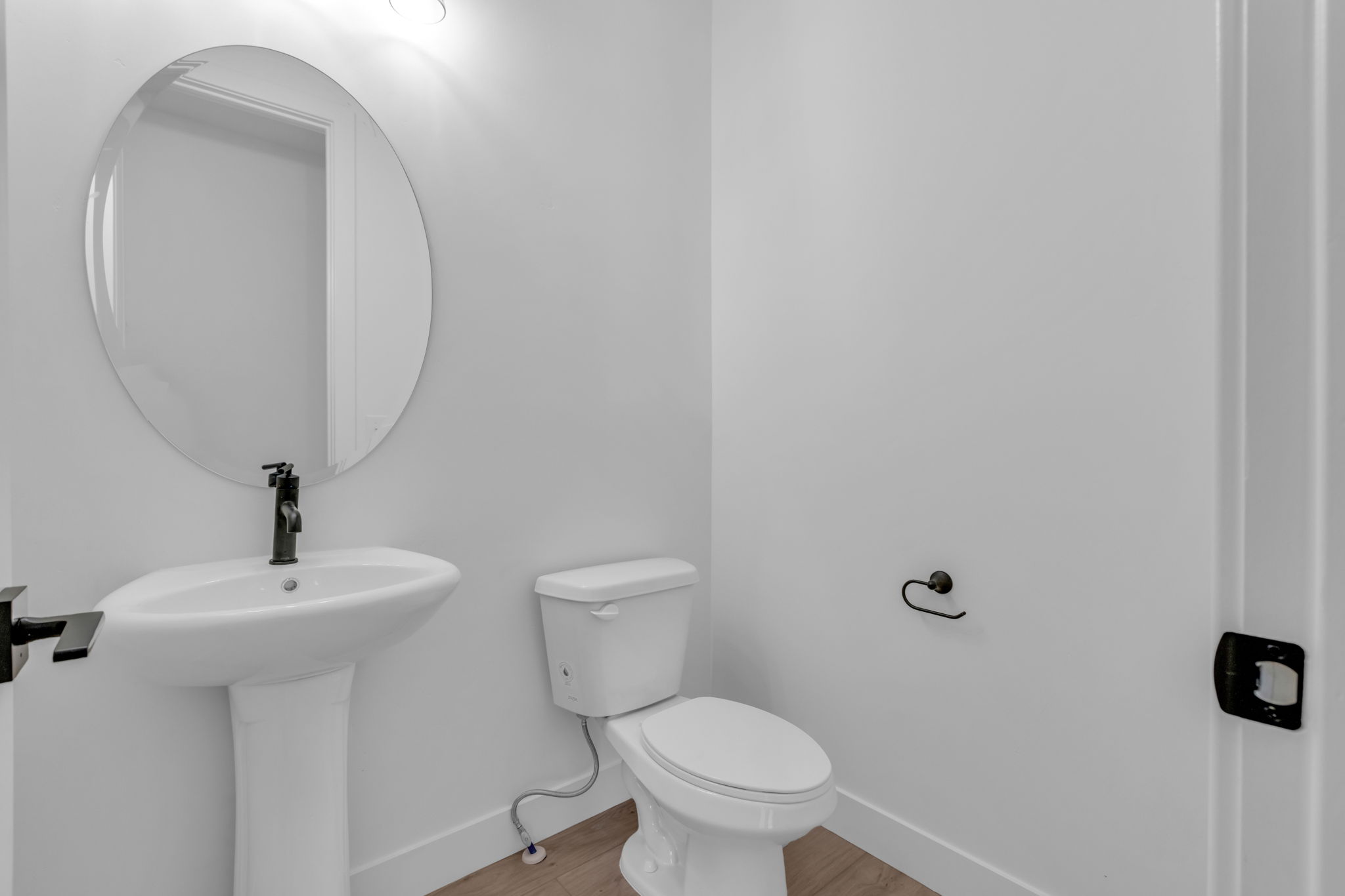 Powder bathroom on main floor with matte black fixtures.