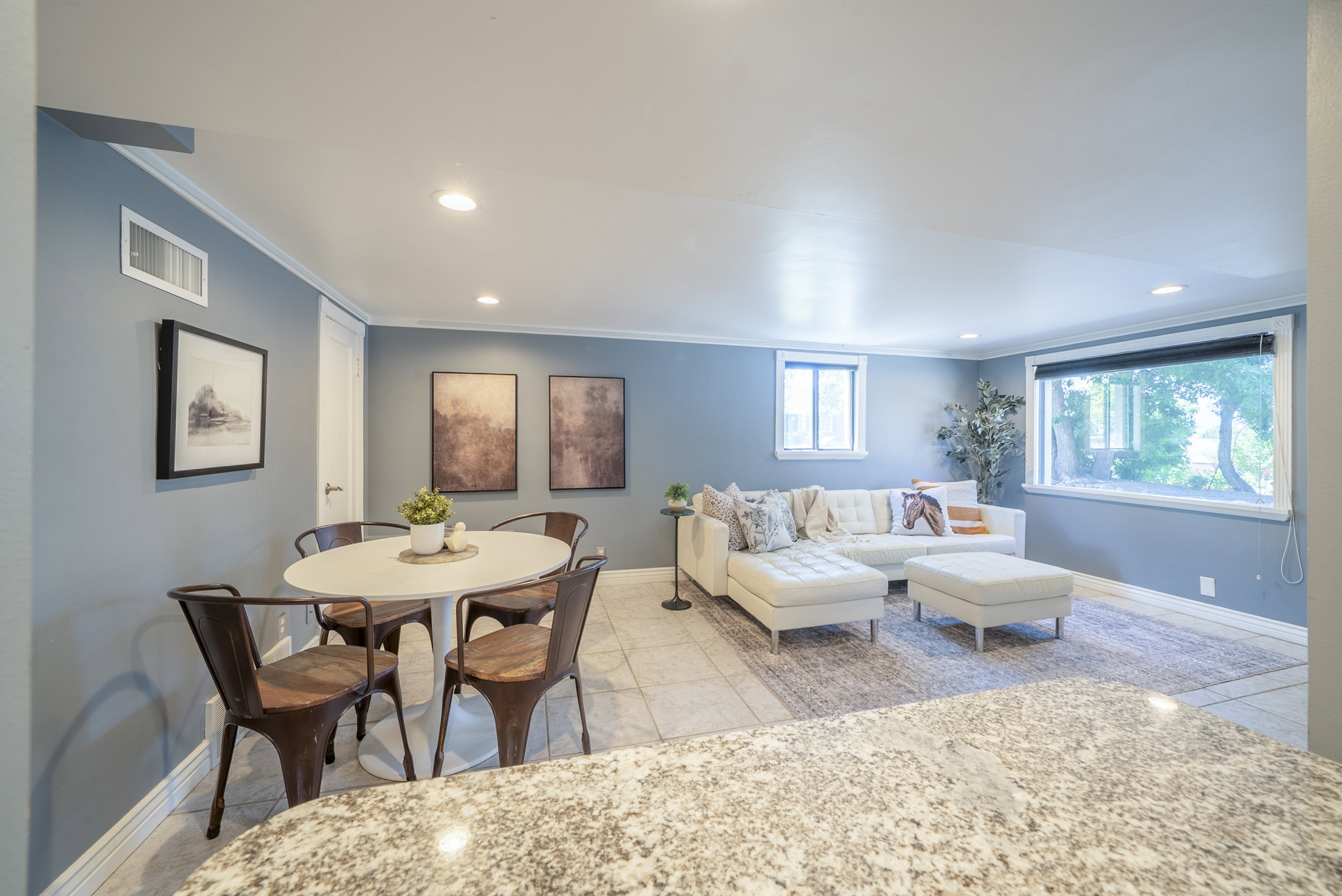 Open concept living space with recessed lighting and crown molding