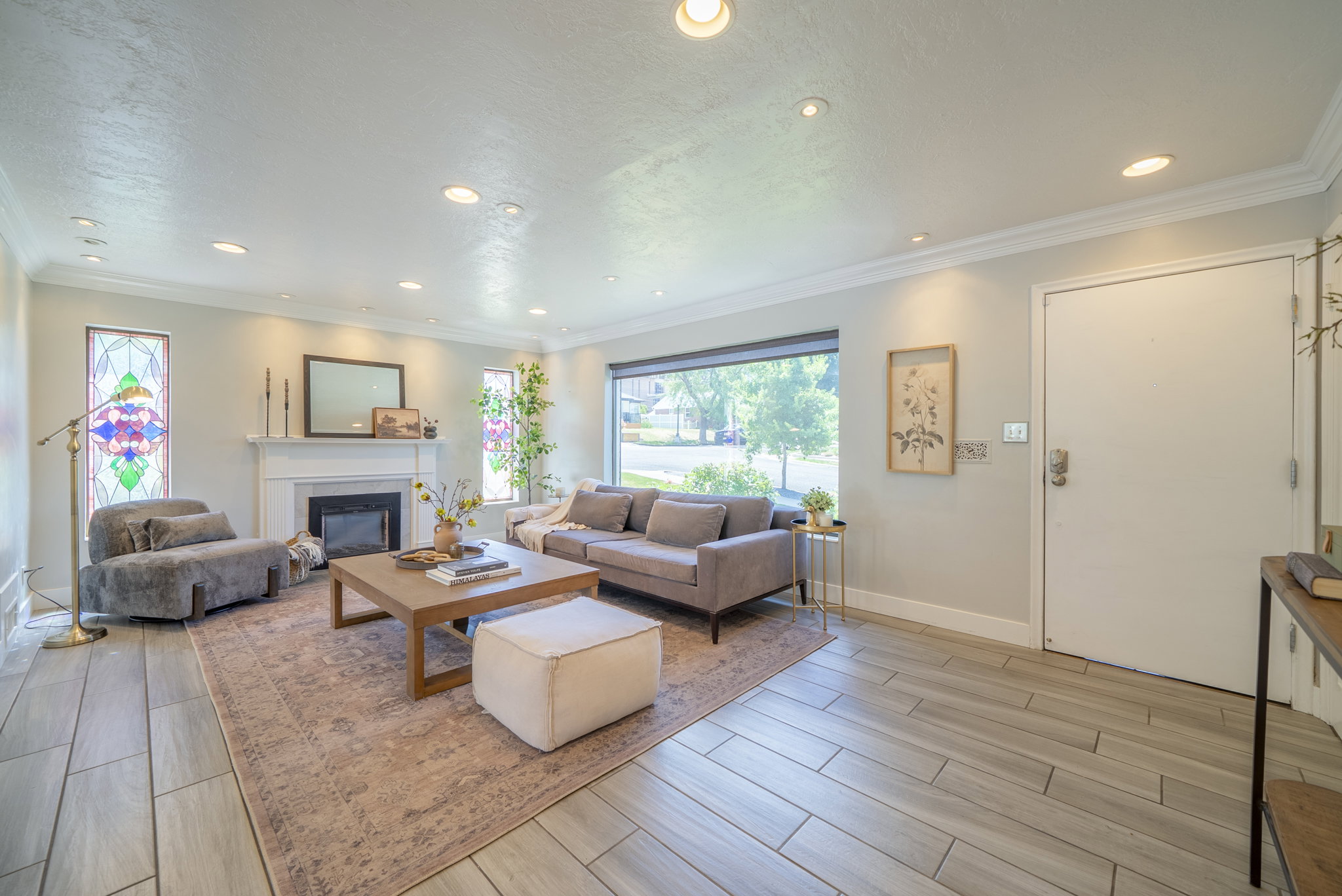 Living area featuring light wood-finish flooring and recessed lighting