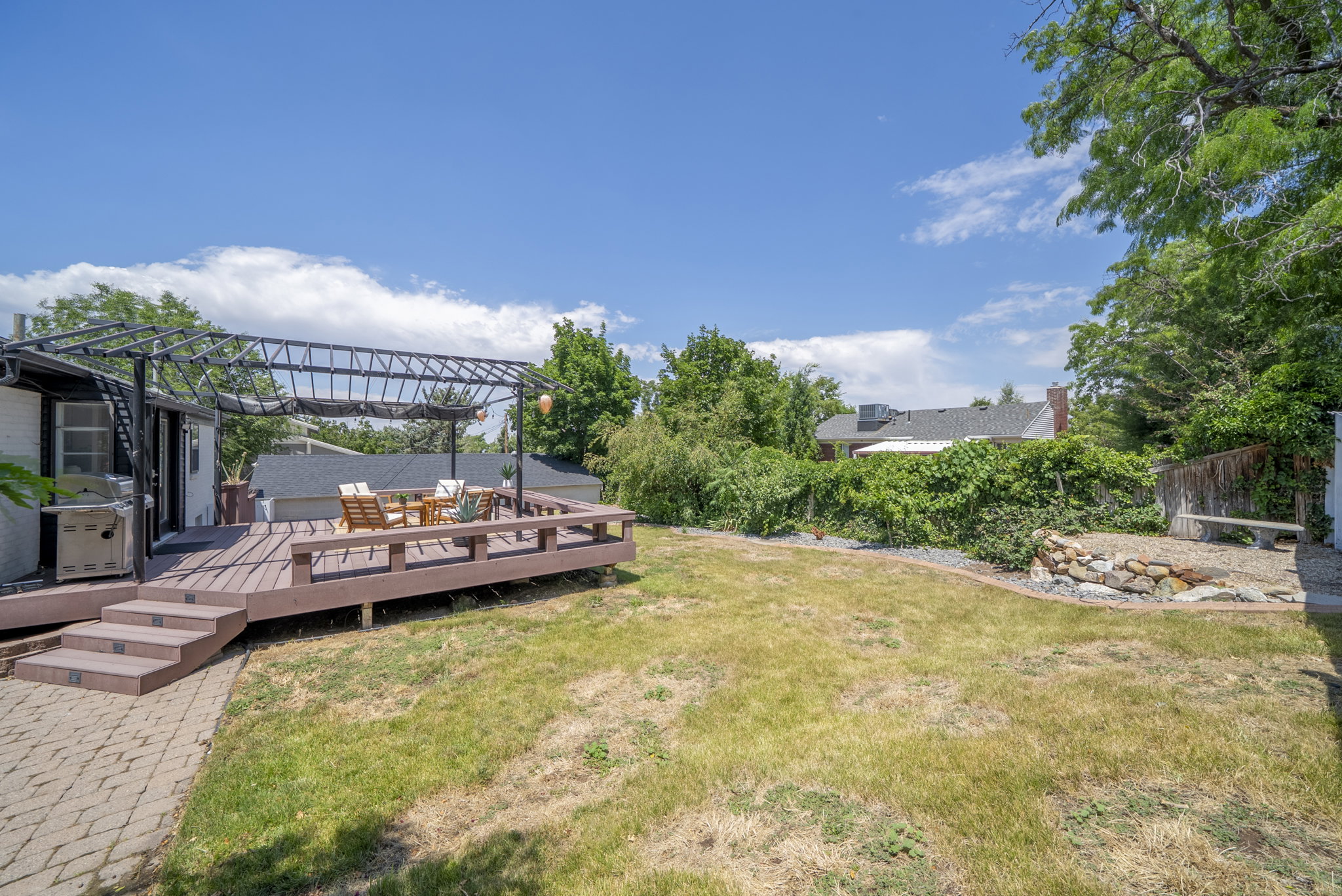 Spacious outdoor deck with a metal pergola structure