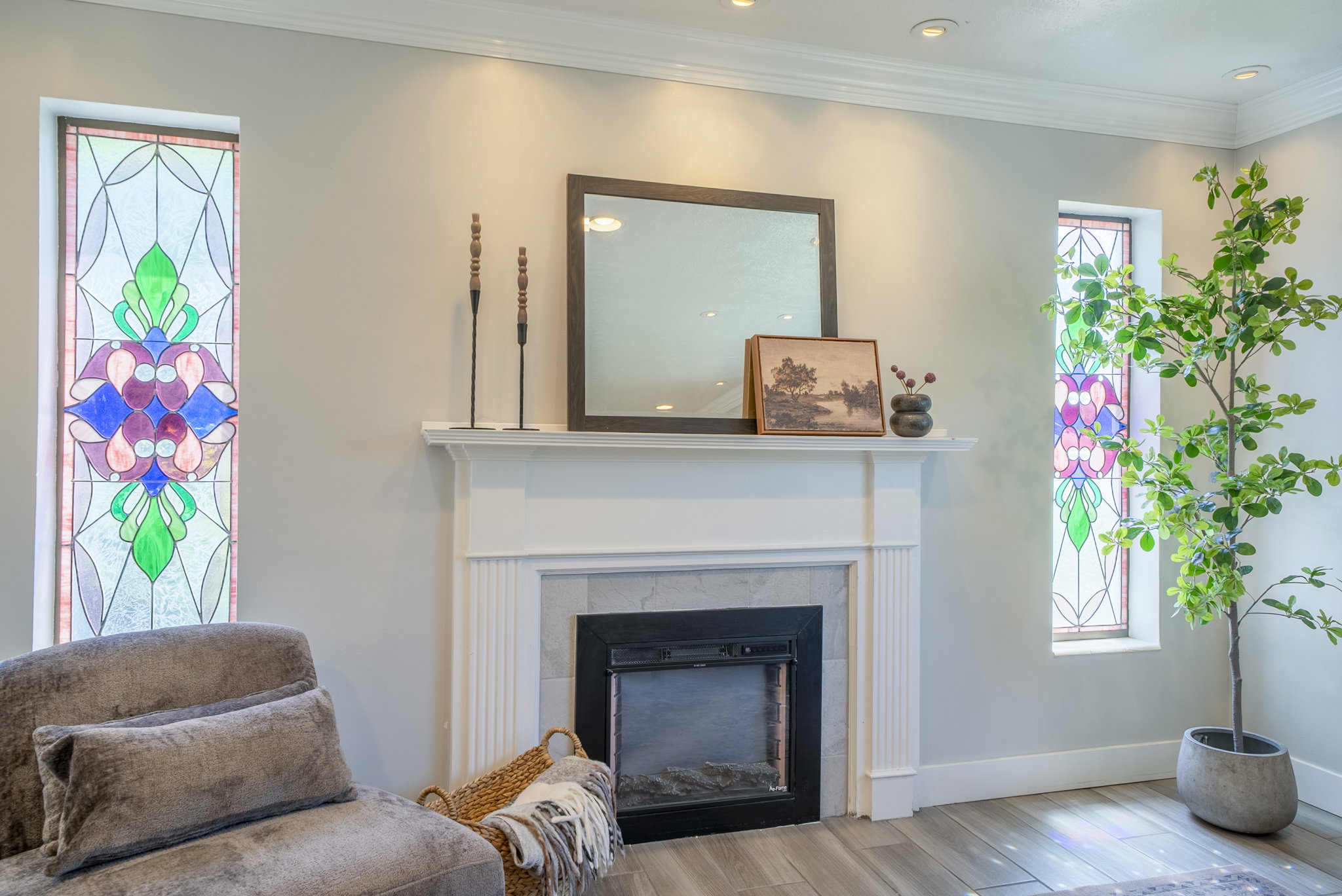 Fireplace featuring a white mantel, tile surround, and an electric insert
