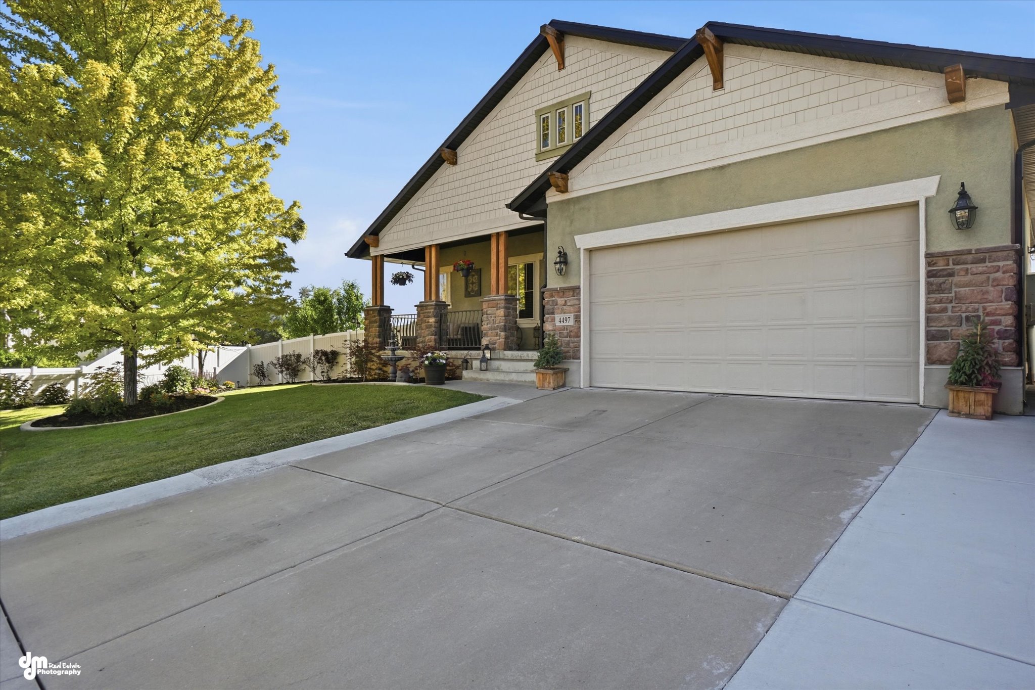 Front exterior featuring a concrete driveway, attached two-car garage, and a covered porch entry