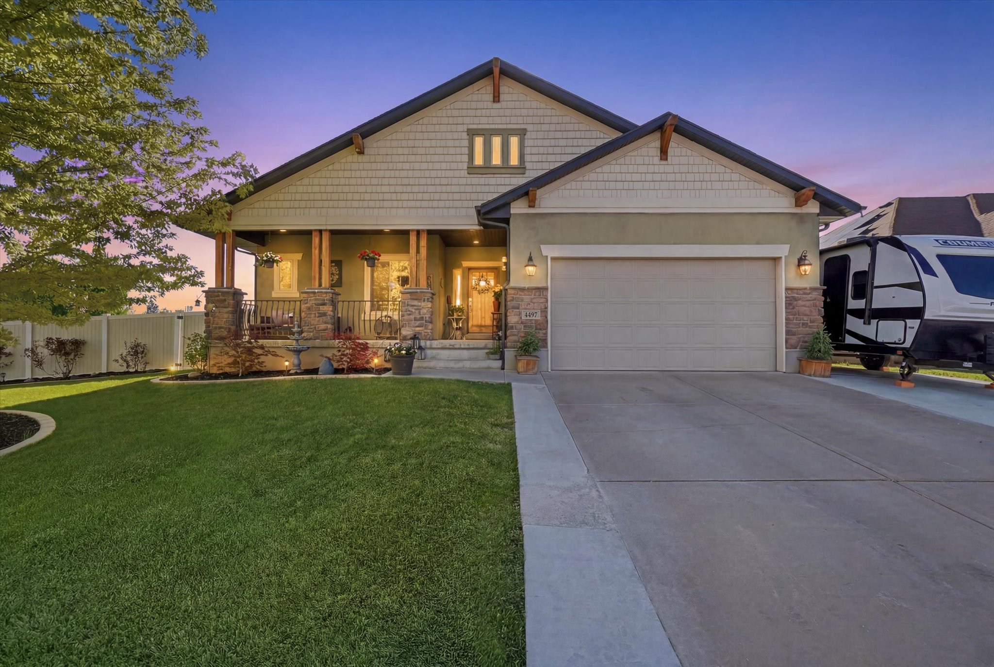 Craftsman-style exterior featuring a covered front porch with stone columns and wood accents