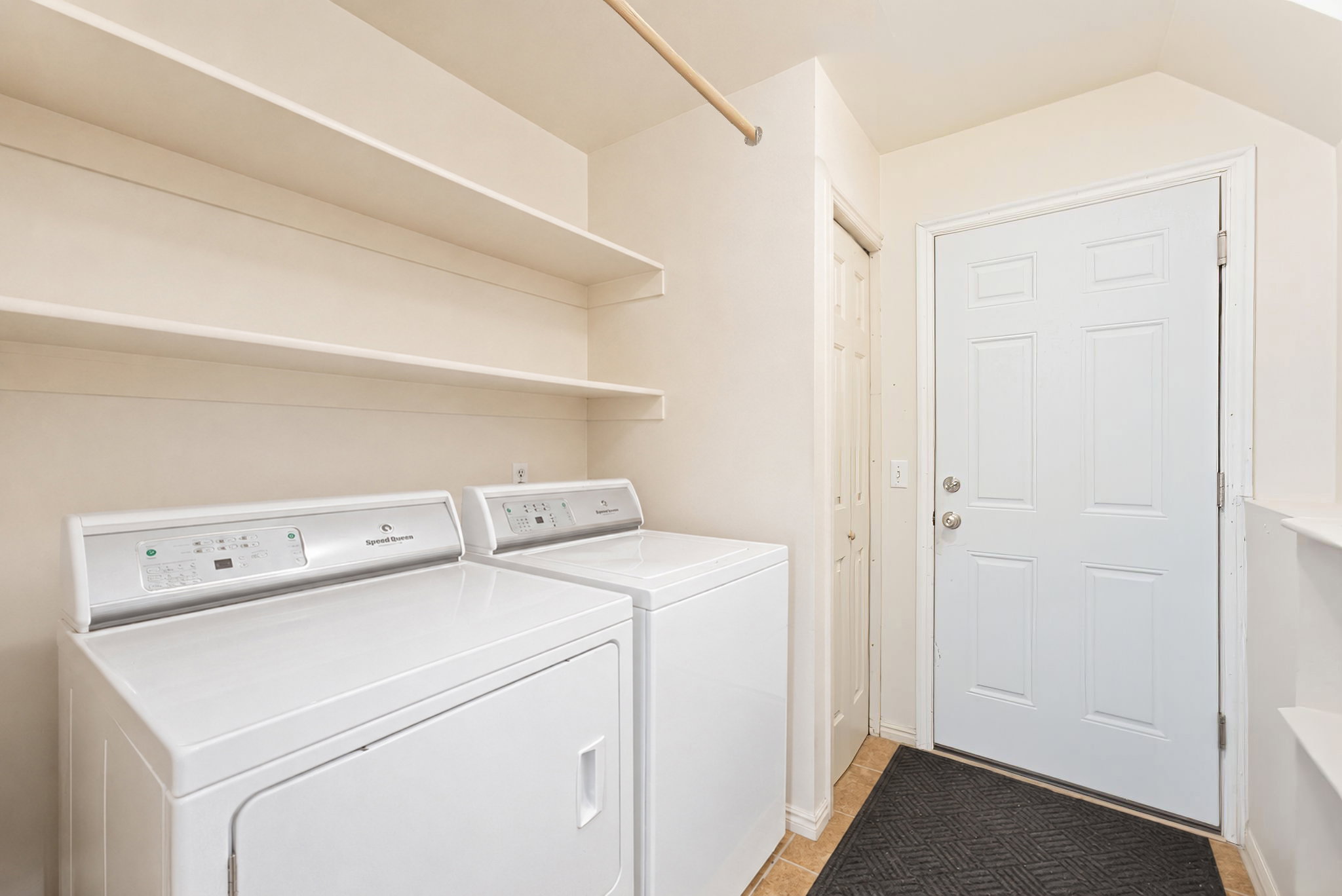 Dedicated laundry area featuring white washer and dryer units